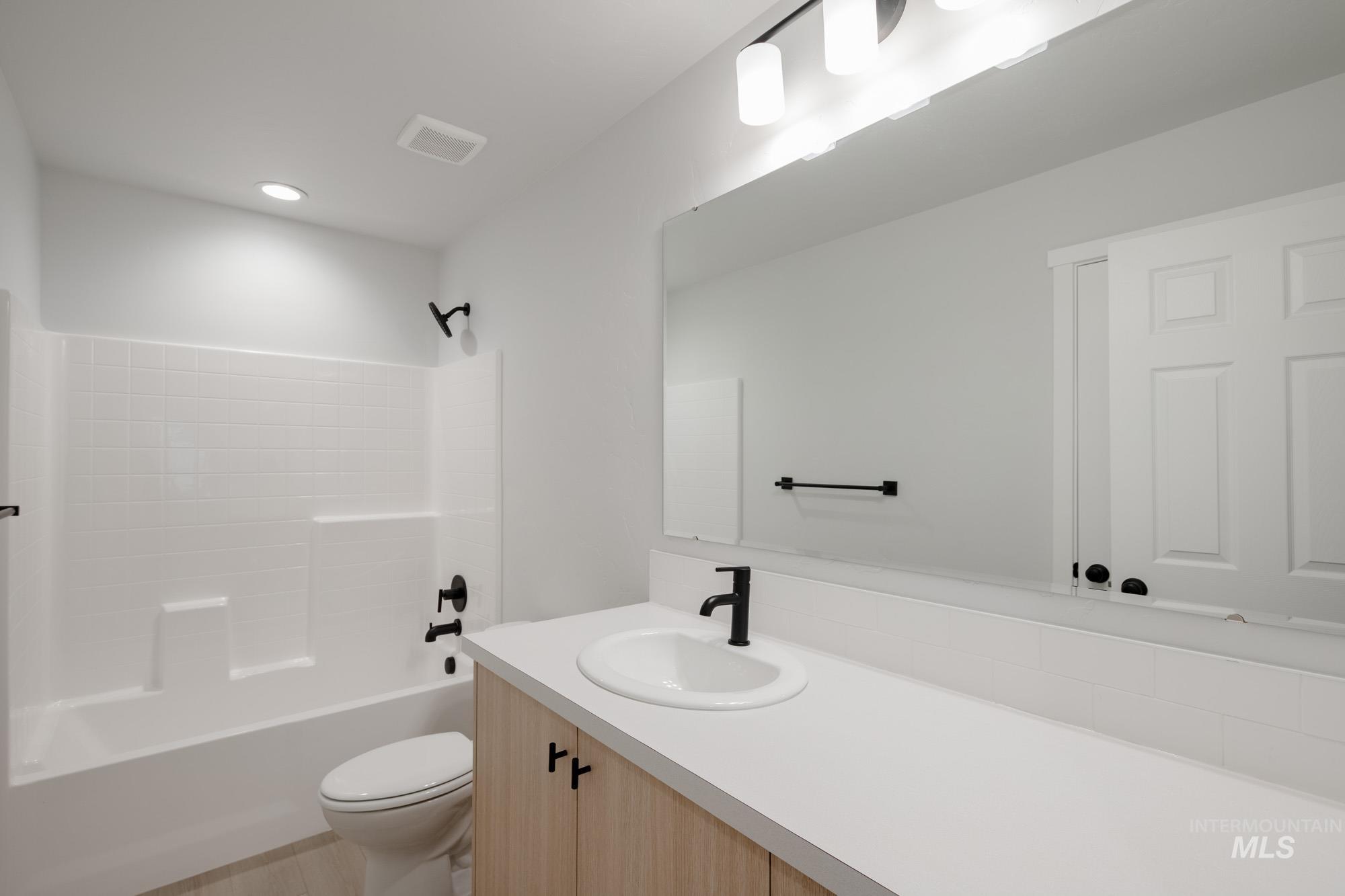 Full bath featuring vanity,  shower combination, and recessed lighting