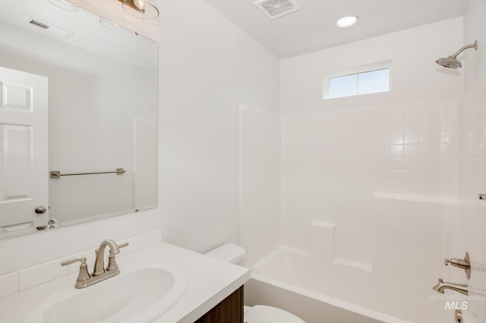 Bathroom with shower / tub combination and vanity