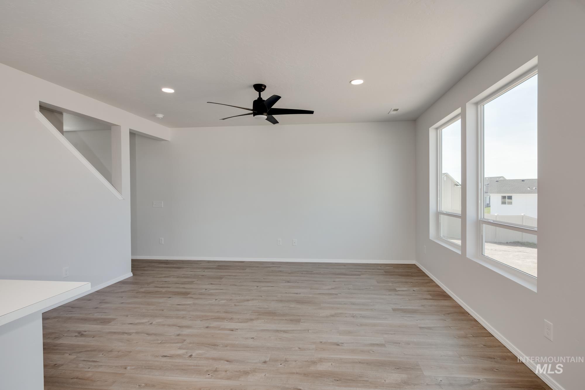 Spare room with light wood finished floors, recessed lighting, and ceiling fan