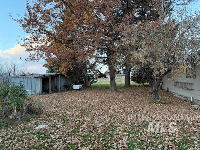 View of yard with a pole building and an outbuilding