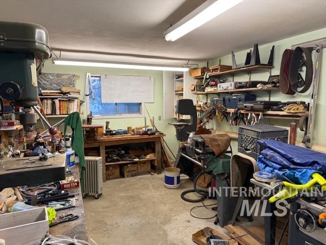 Storage room featuring radiator heating unit