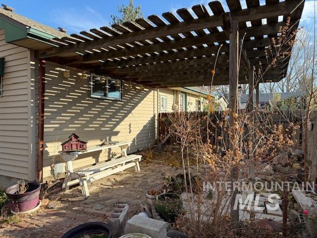 View of side of home featuring a pergola and a patio area