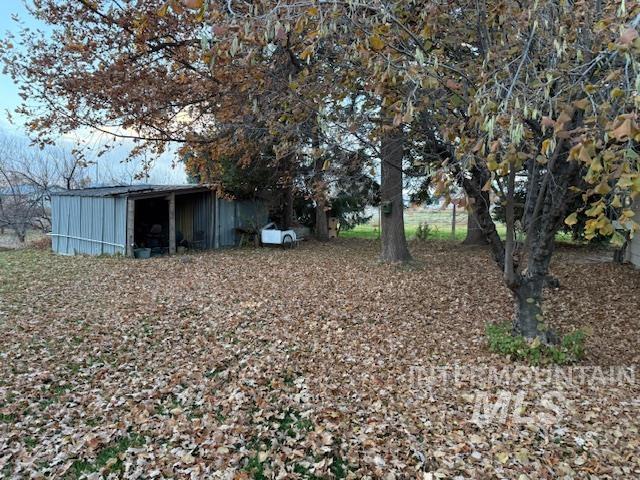 View of yard featuring an outbuilding and a pole building