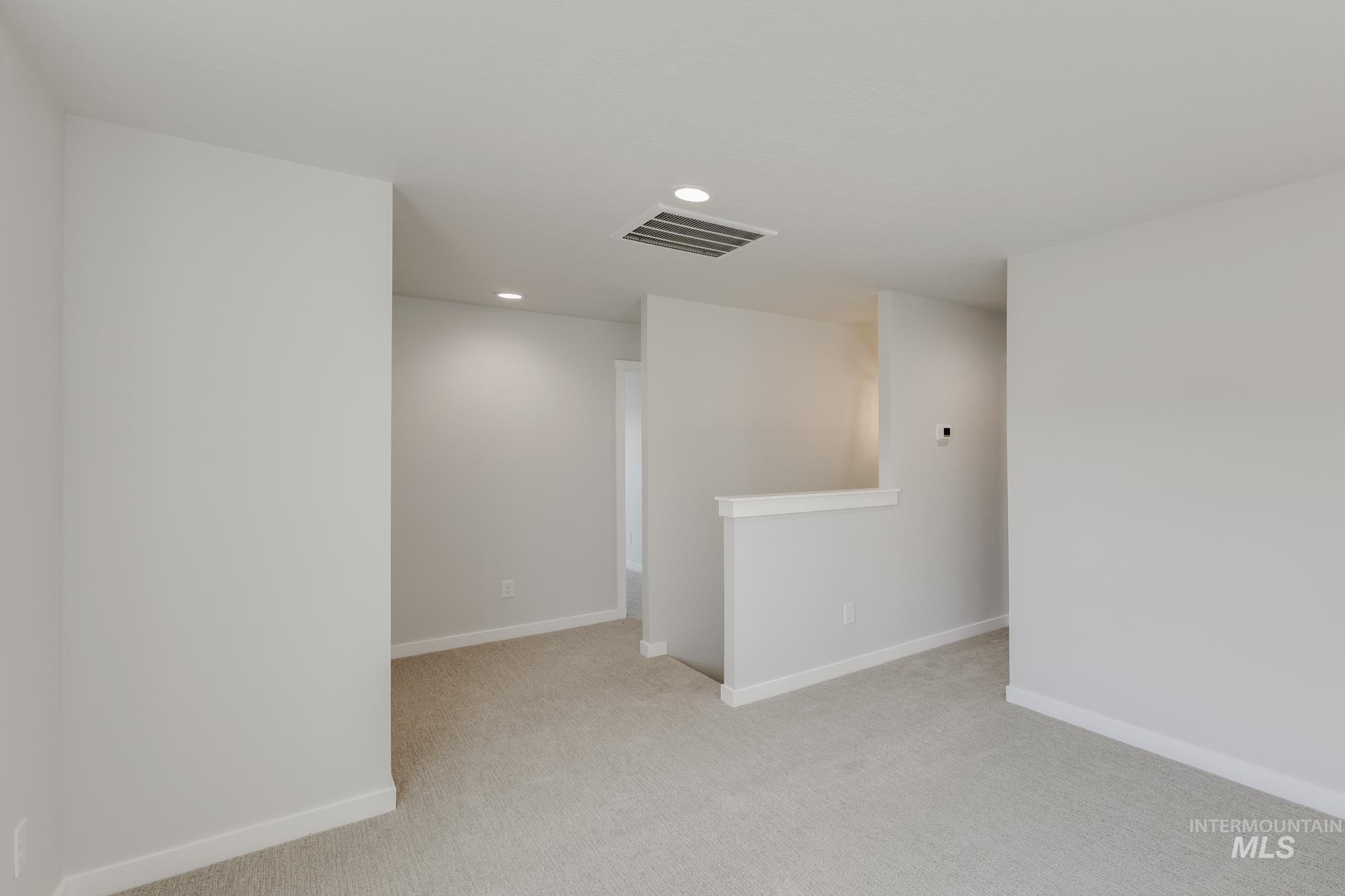 Unfurnished room featuring light carpet and recessed lighting