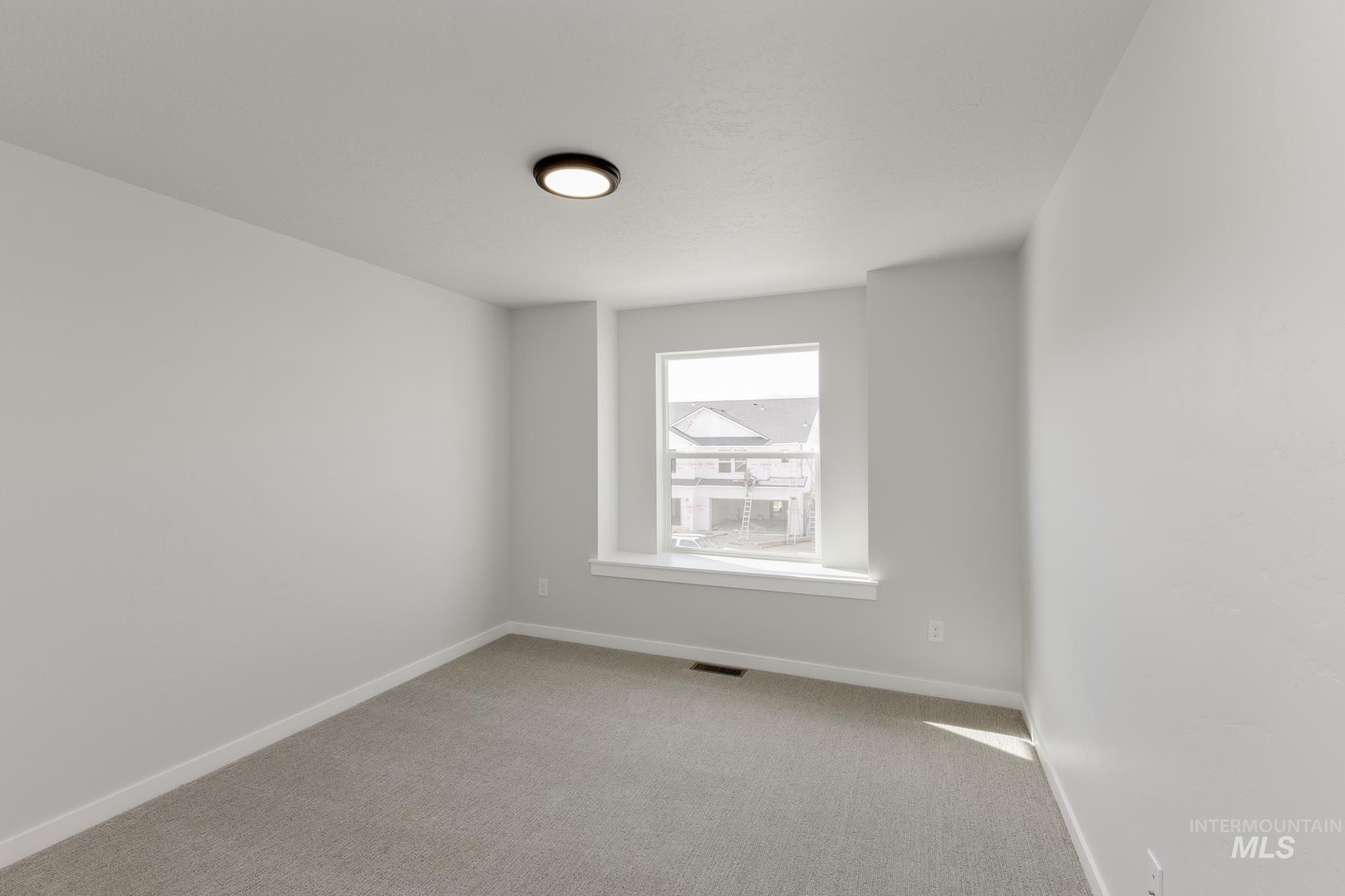 Empty room featuring carpet floors and baseboards
