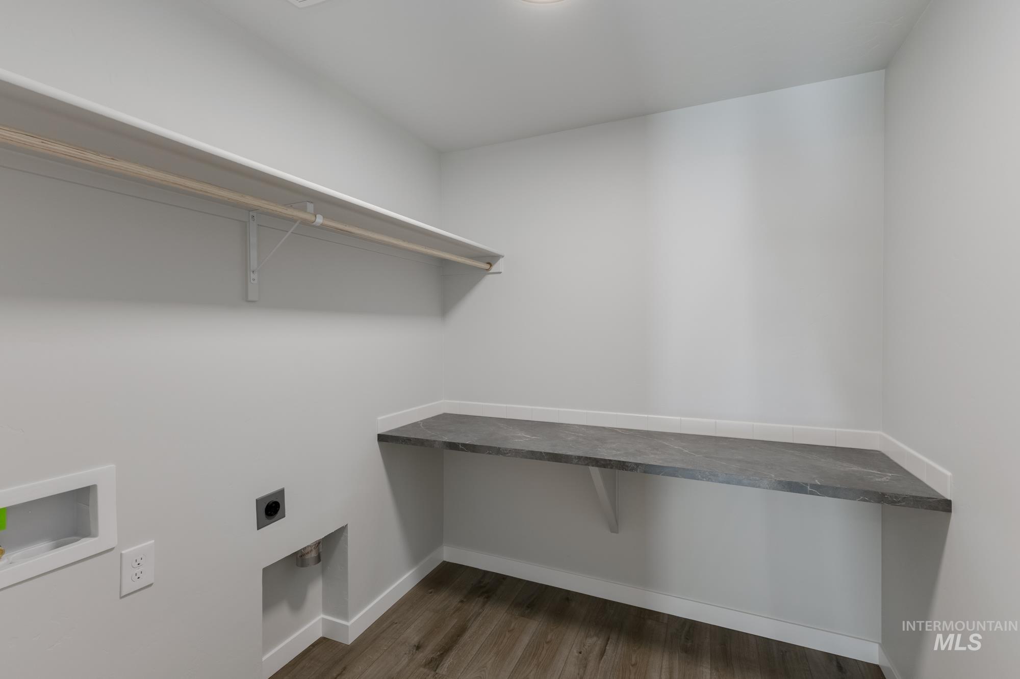 Washroom featuring dark wood-style flooring, electric dryer hookup, and washer hookup