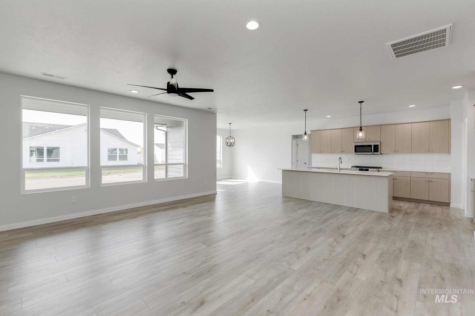 Unfurnished living room with light wood finished floors, recessed lighting, and a ceiling fan