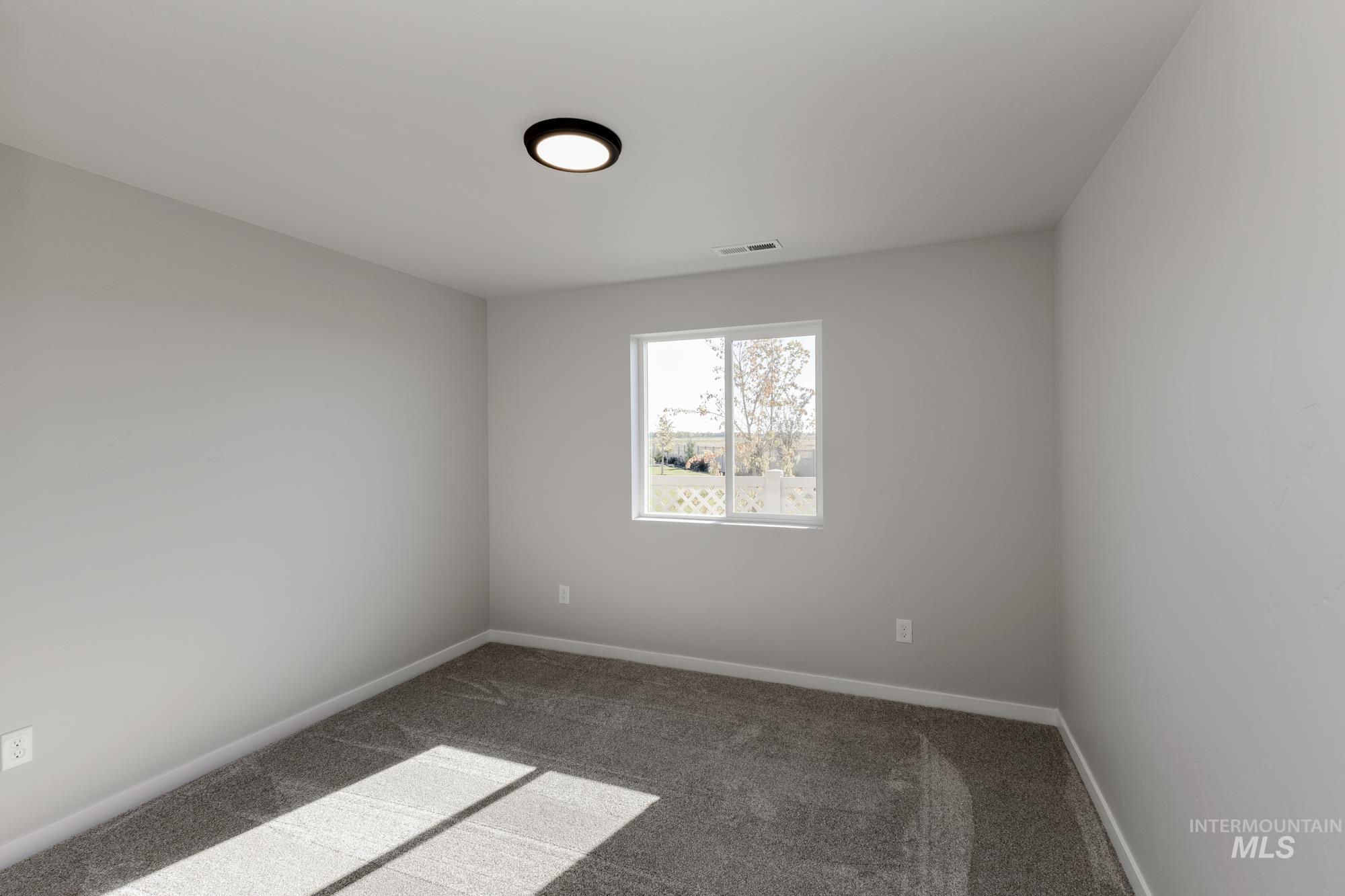 Spare room with carpet flooring and baseboards