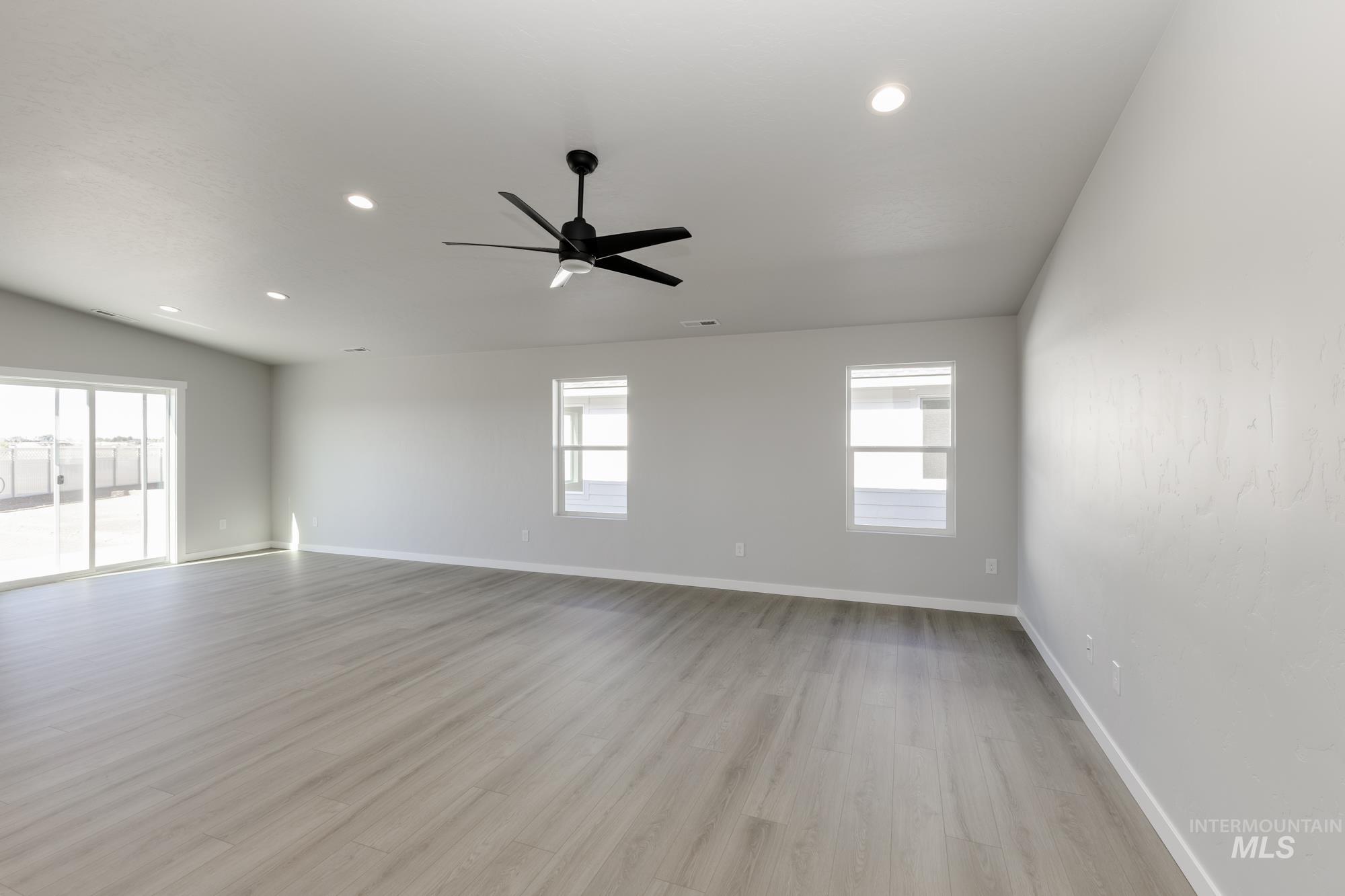 Empty room with light wood finished floors, recessed lighting, and ceiling fan
