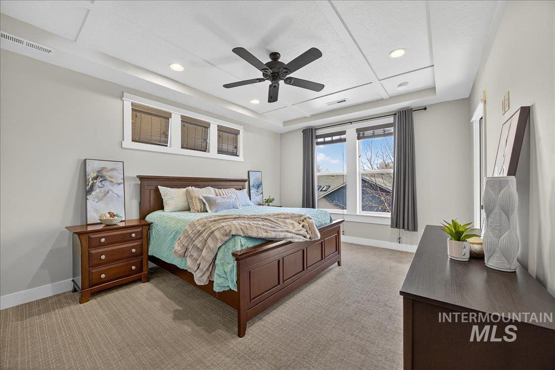 Bedroom featuring a tray ceiling, carpet, ceiling fan, and recessed lighting