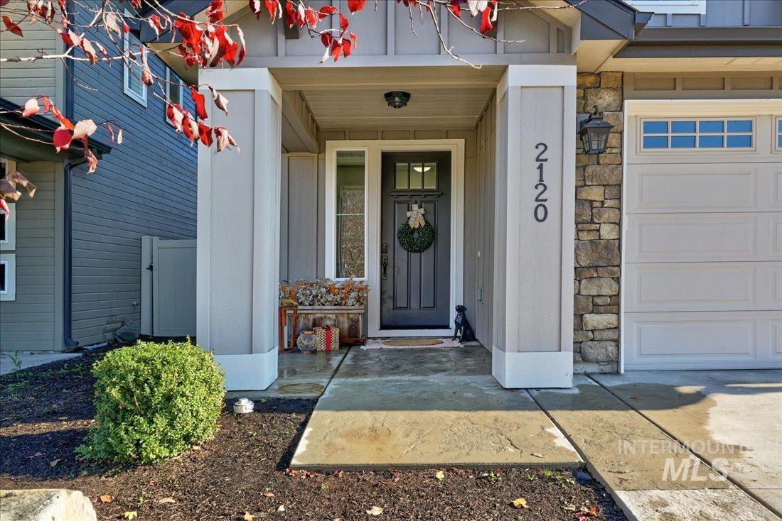 Doorway to property with stone siding
