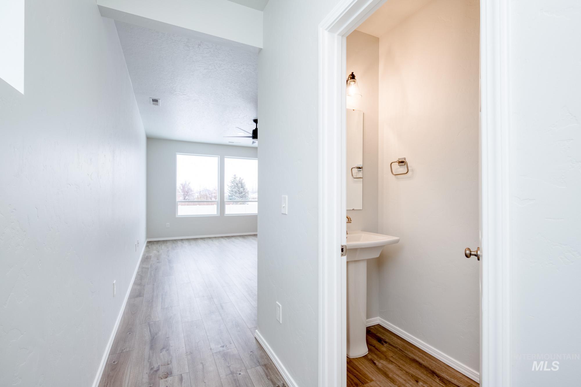 Hallway featuring light wood-style floors and a textured ceiling