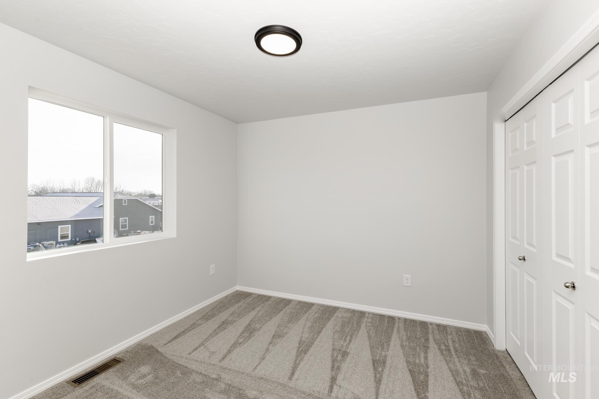 Unfurnished bedroom with carpet flooring and a closet