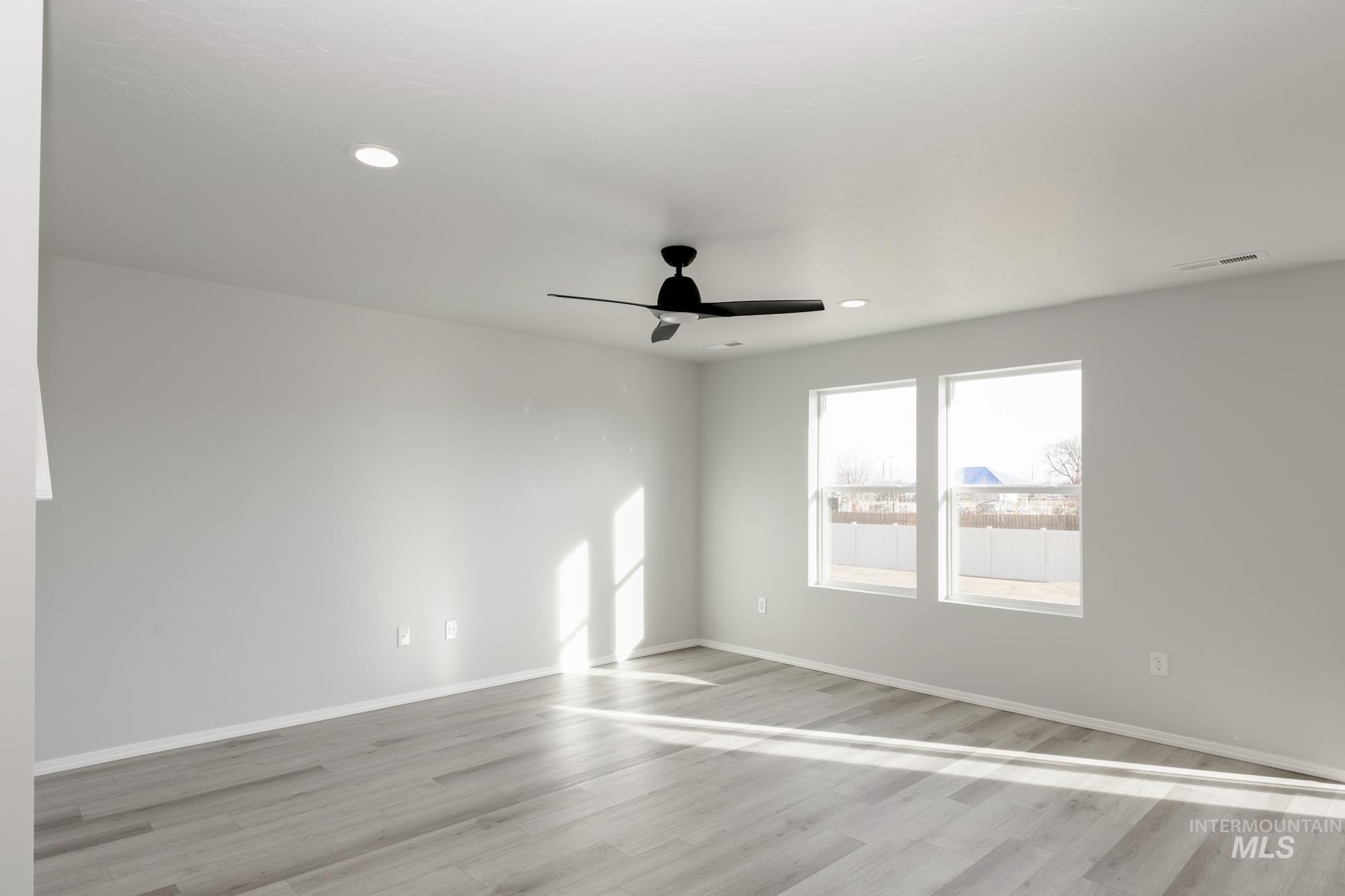 Spare room with light wood-style flooring, recessed lighting, and a ceiling fan
