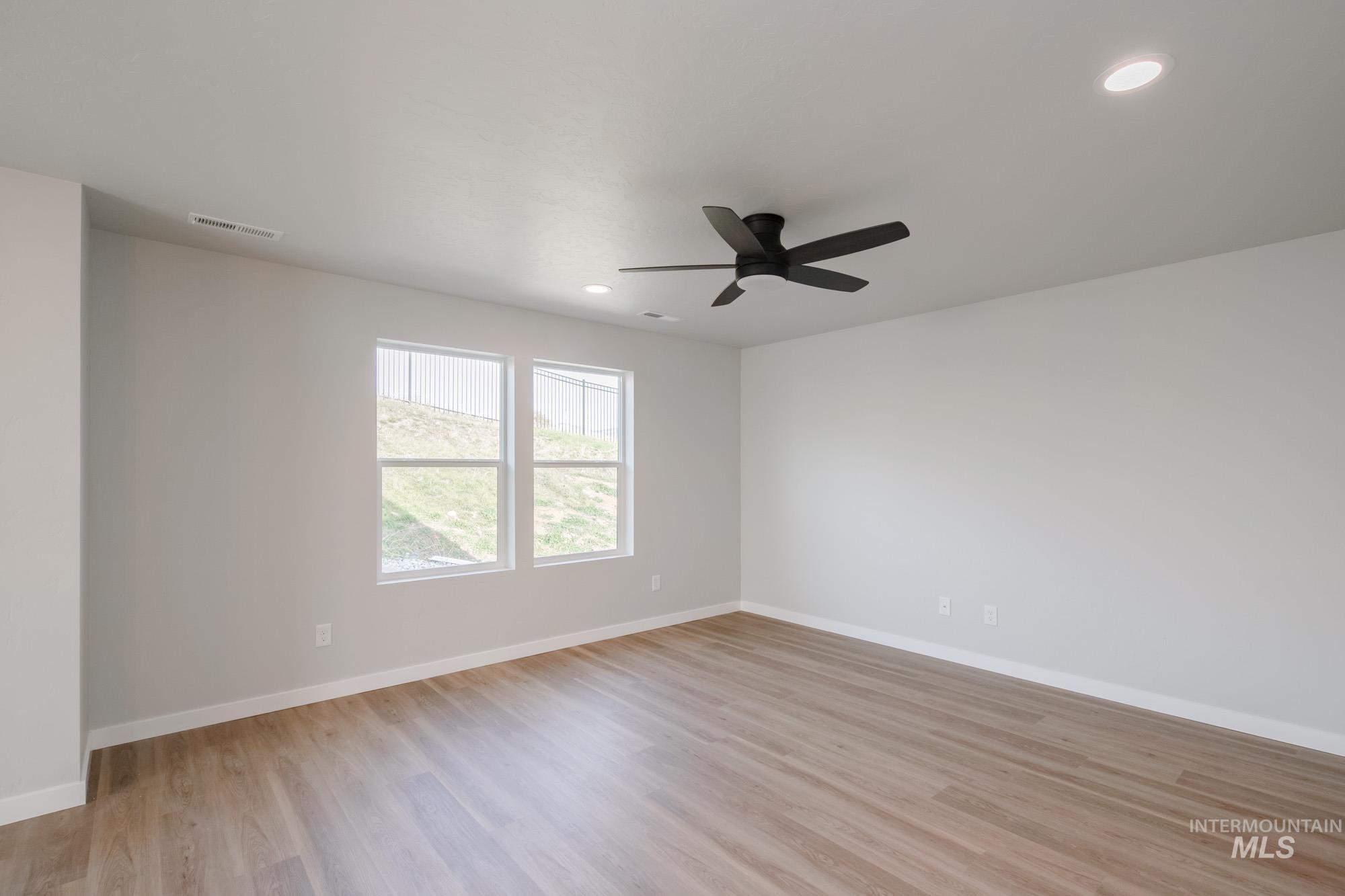 Unfurnished room featuring light wood-type flooring, recessed lighting, and a ceiling fan
