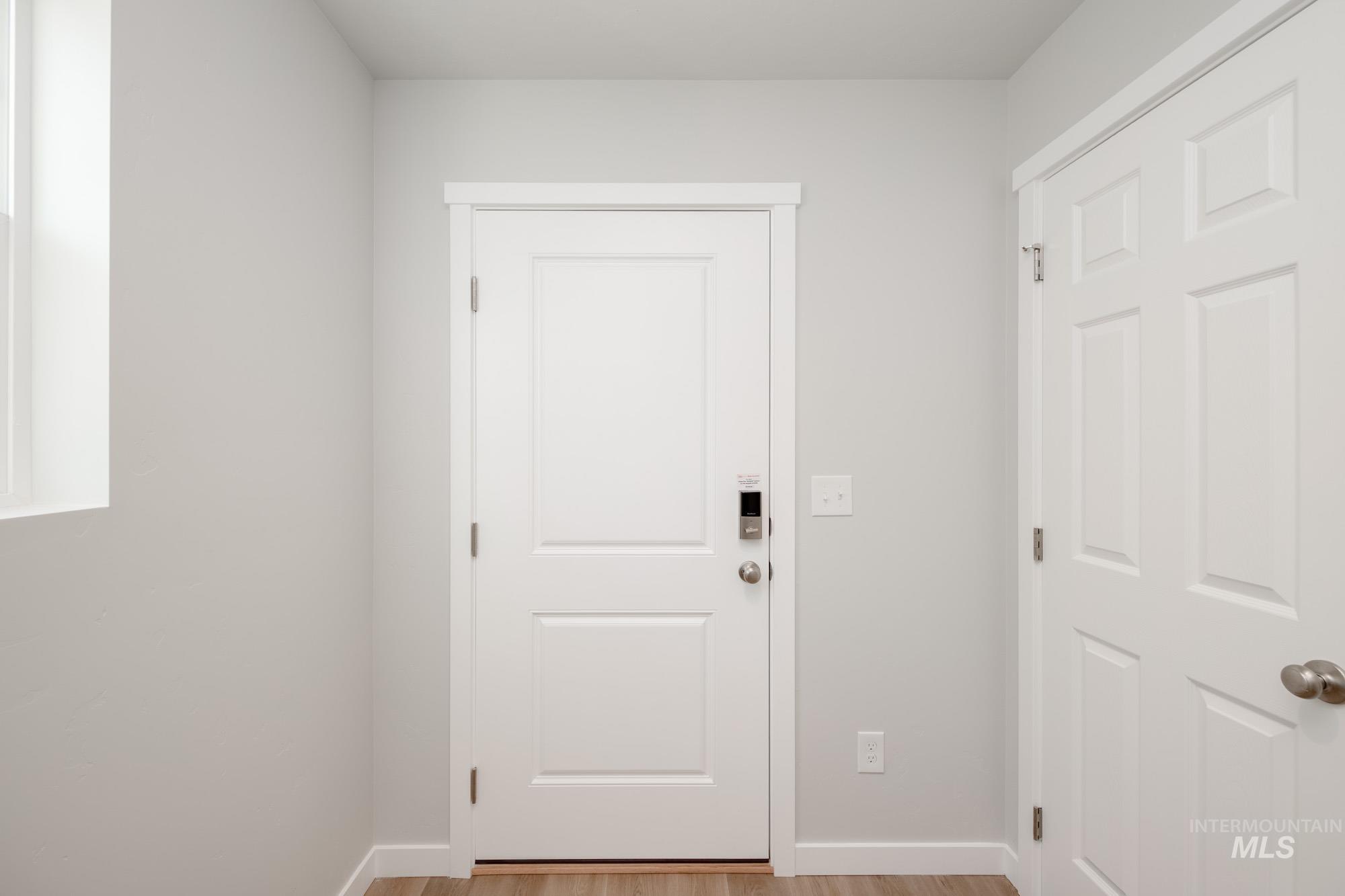 Entryway featuring wood finished floors and baseboards