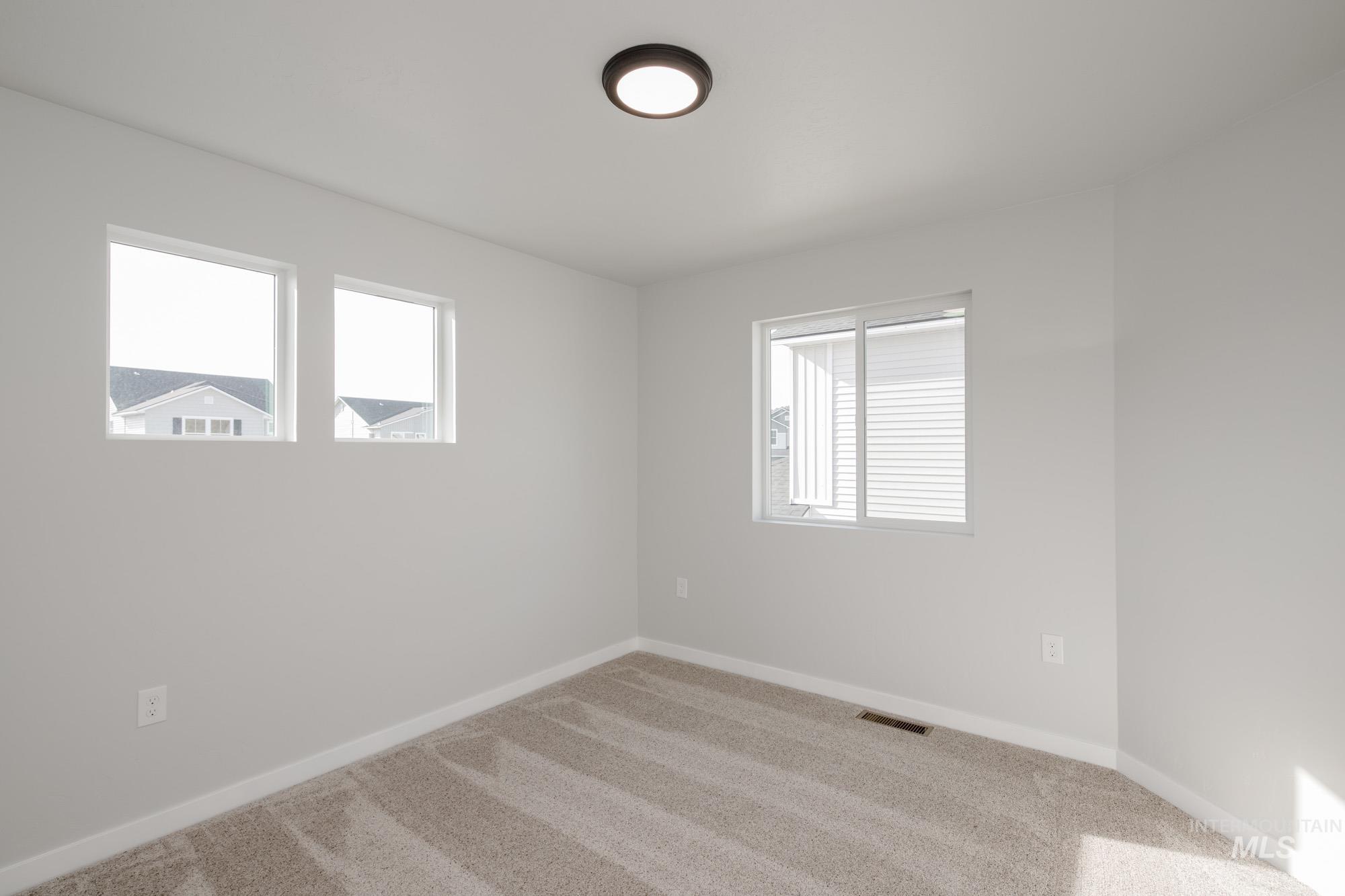 Carpeted empty room with plenty of natural light