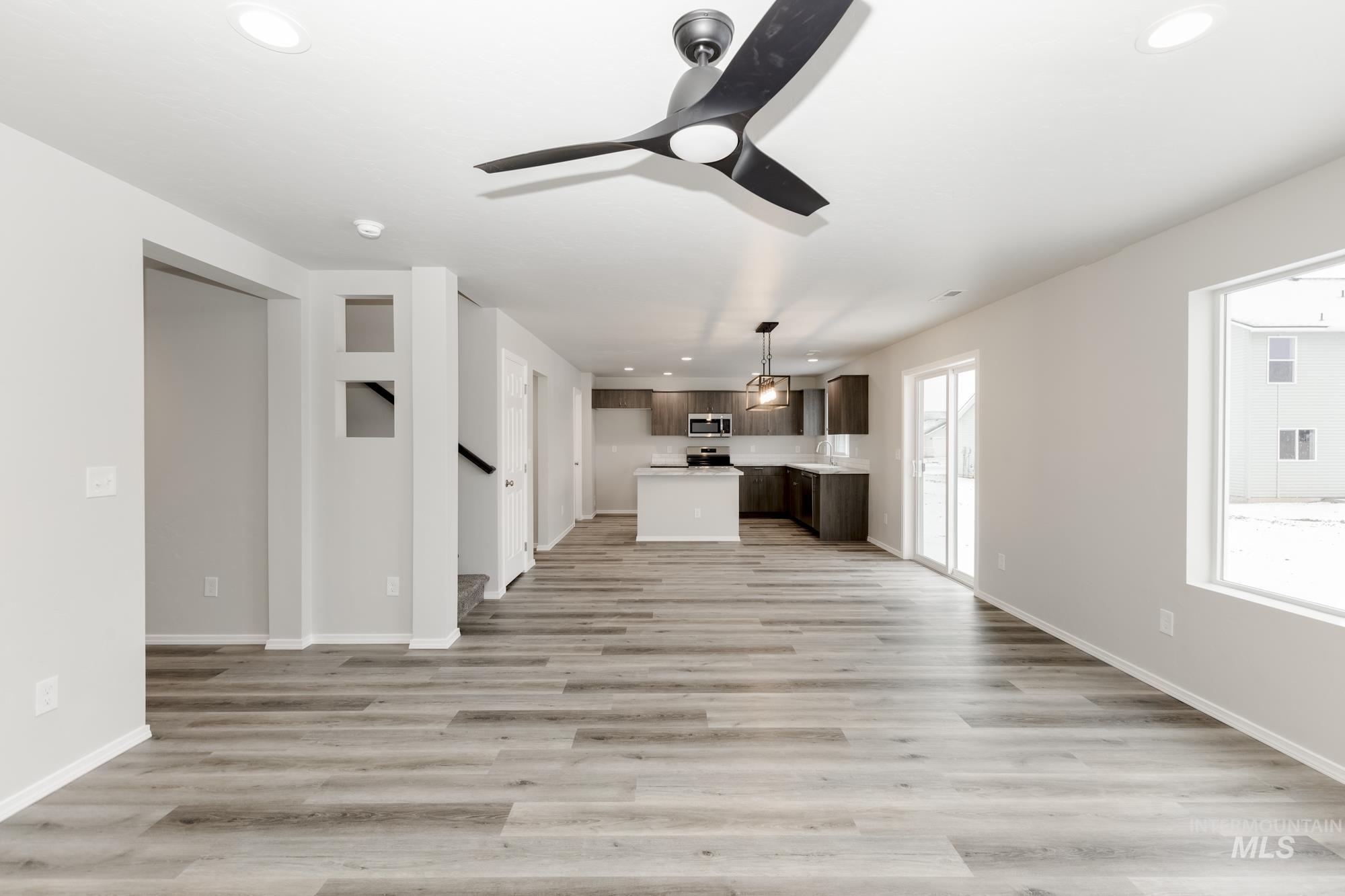 Unfurnished living room with recessed lighting, light wood-style floors, and ceiling fan