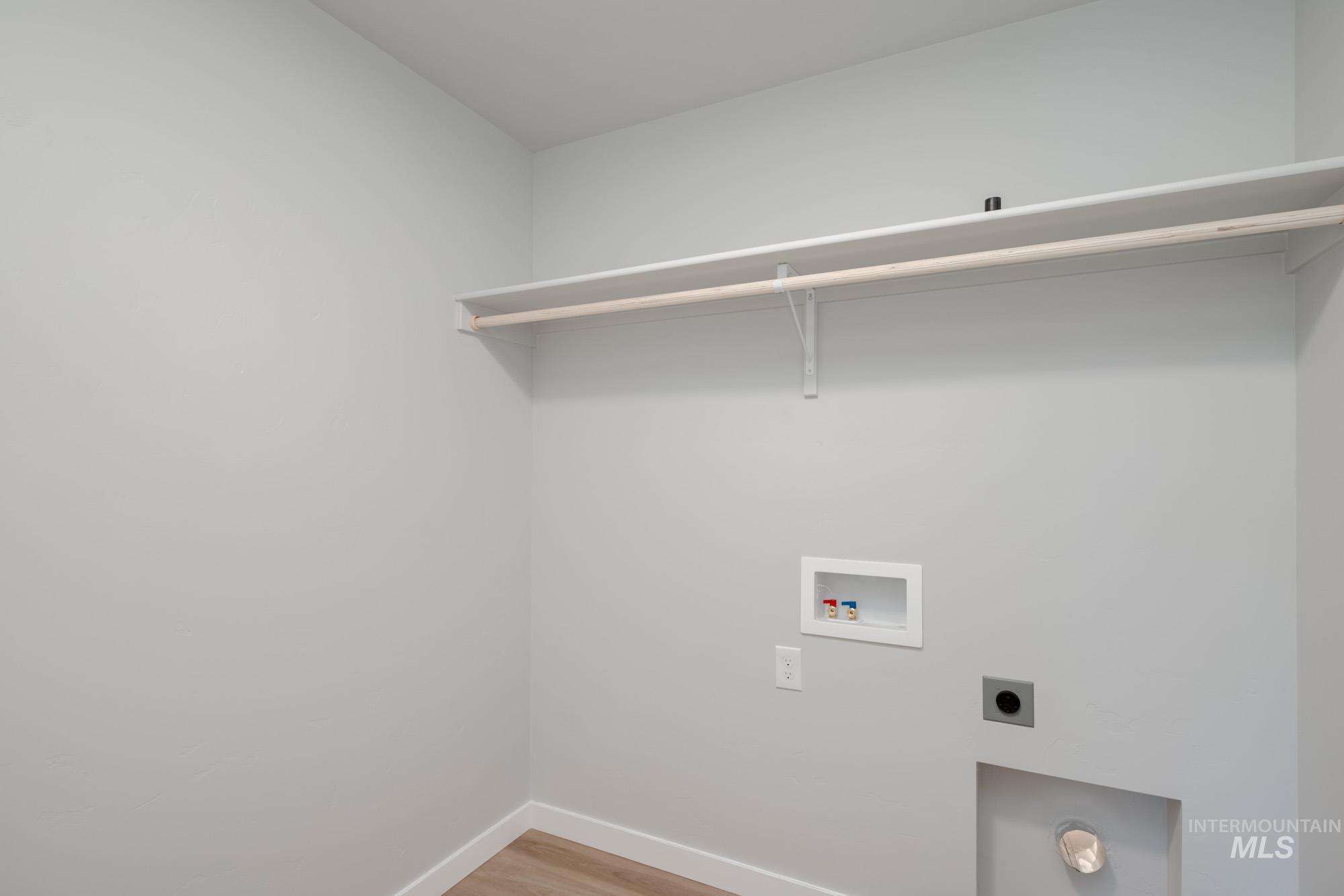 Washroom with washer hookup, light wood-style floors, and hookup for an electric dryer