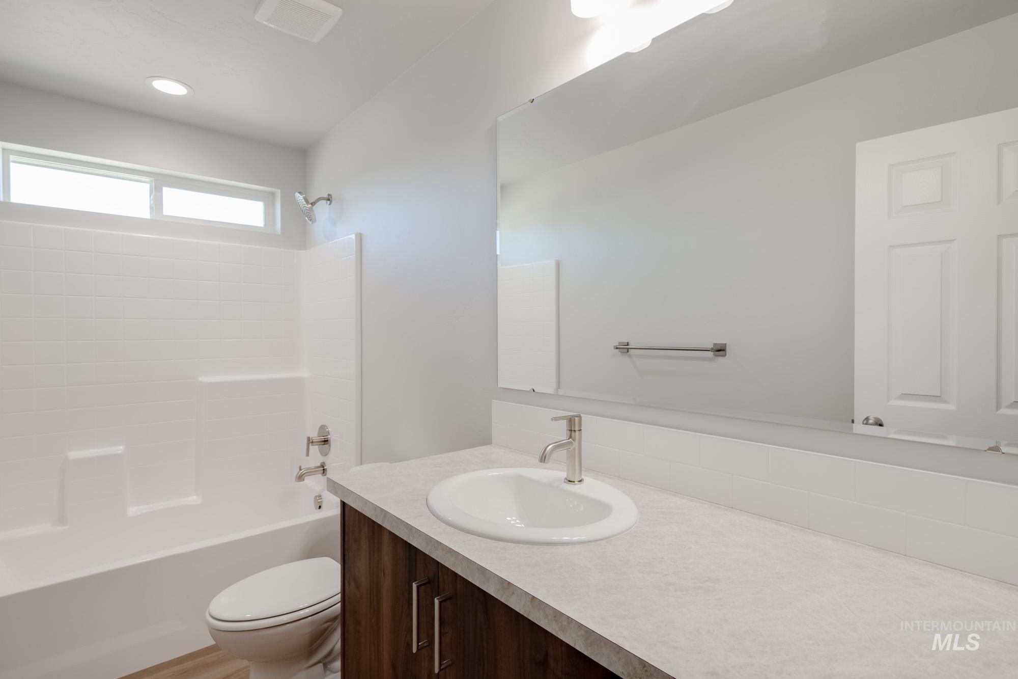 Bathroom with shower / bath combination and vanity