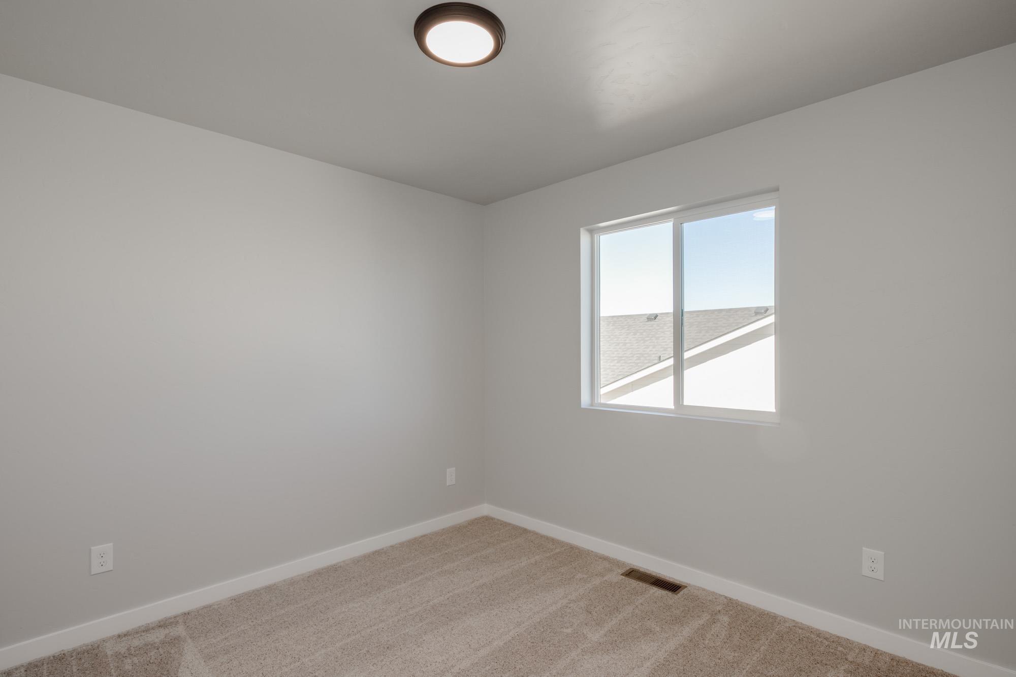Empty room with baseboards and carpet floors