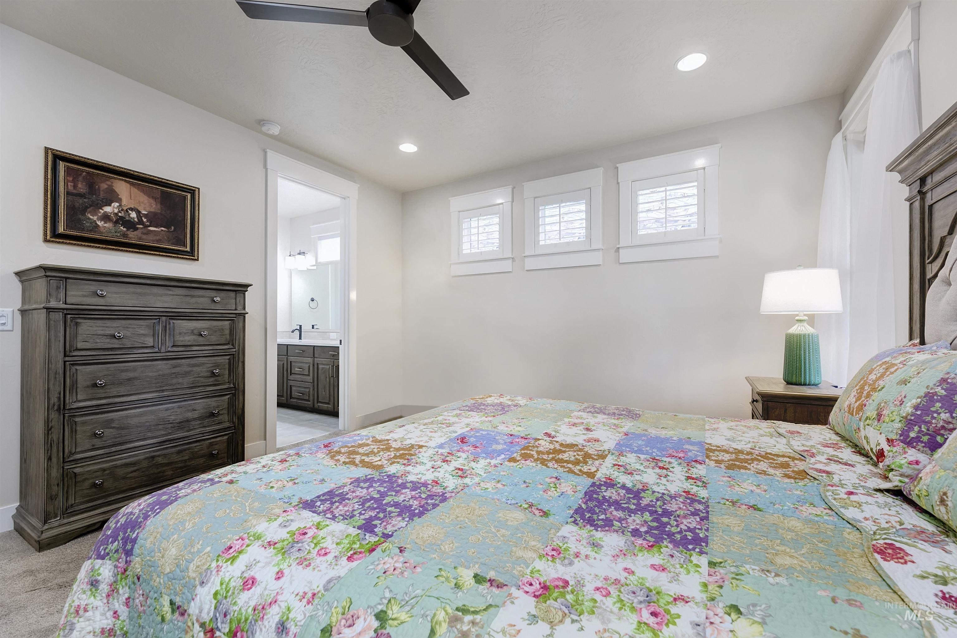 Bedroom with a ceiling fan, connected bathroom, recessed lighting, and light colored carpet