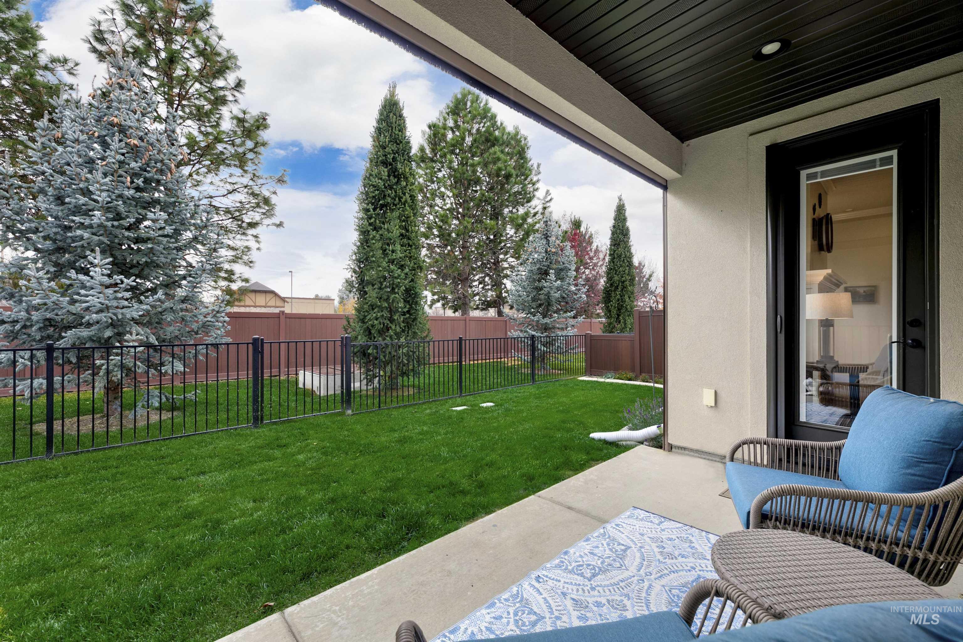Fenced backyard with a patio area