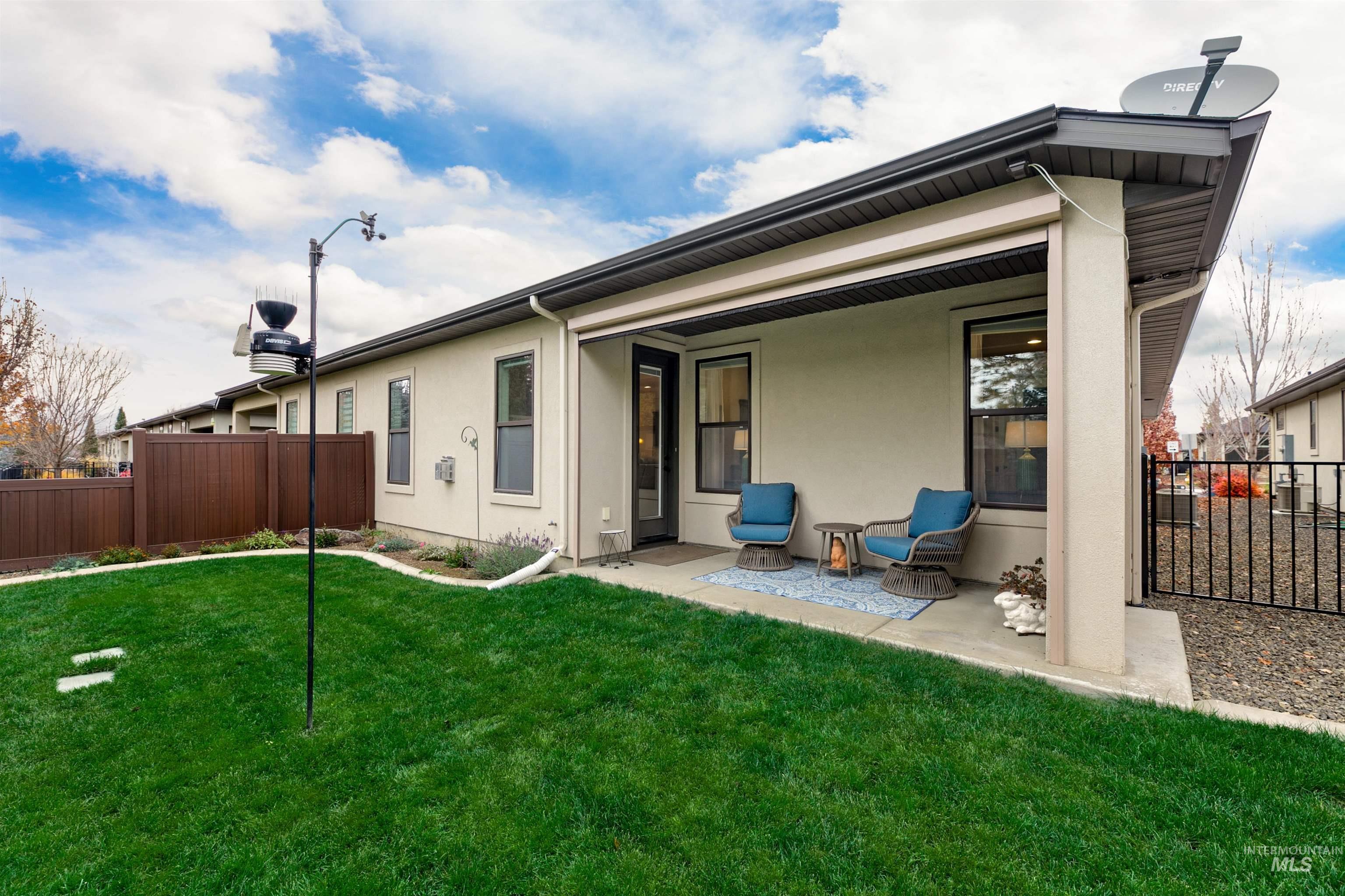 Rear view of property featuring stucco siding and a patio area