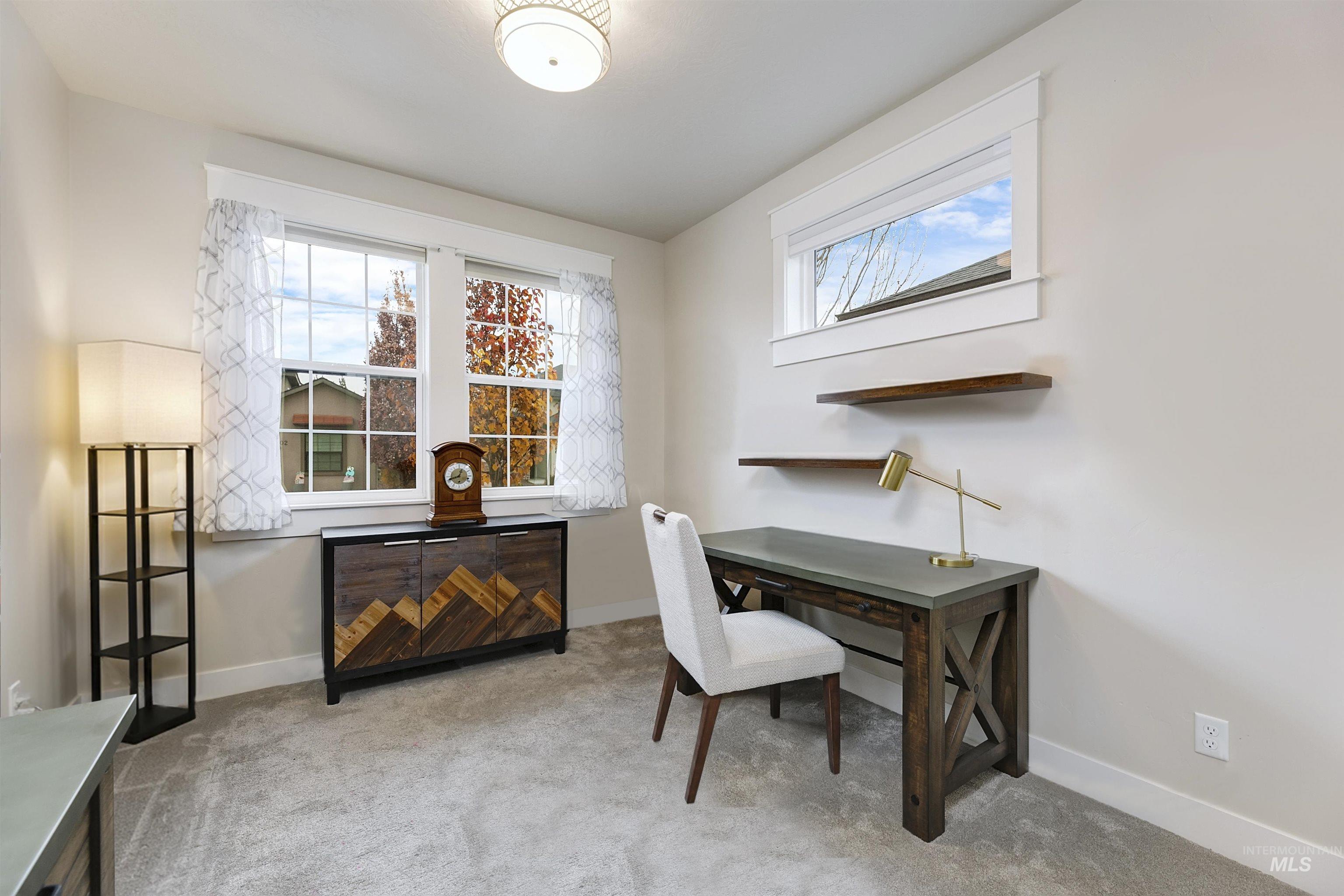 Office featuring light carpet and healthy amount of natural light