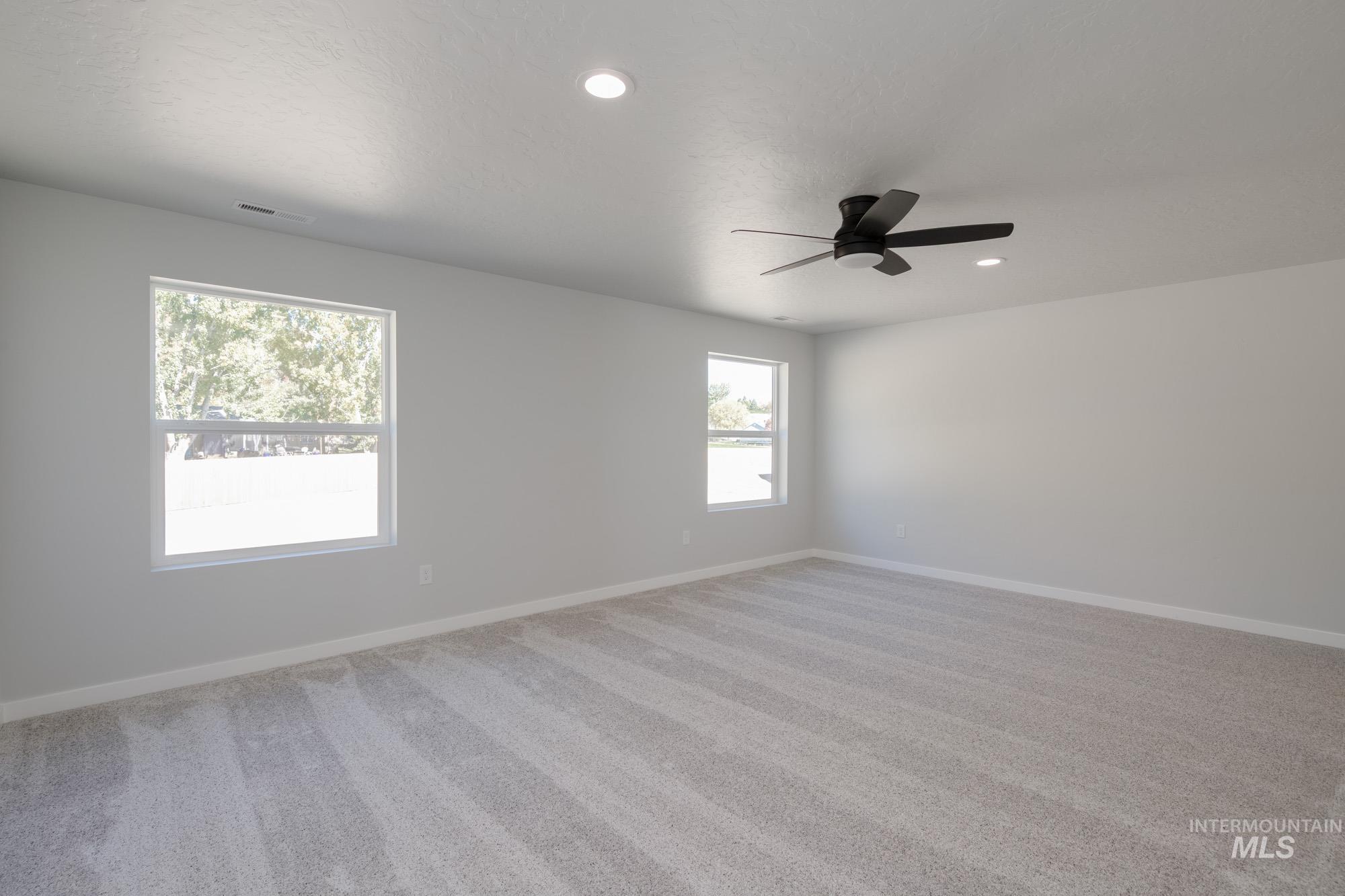 Unfurnished room with light carpet, recessed lighting, and ceiling fan