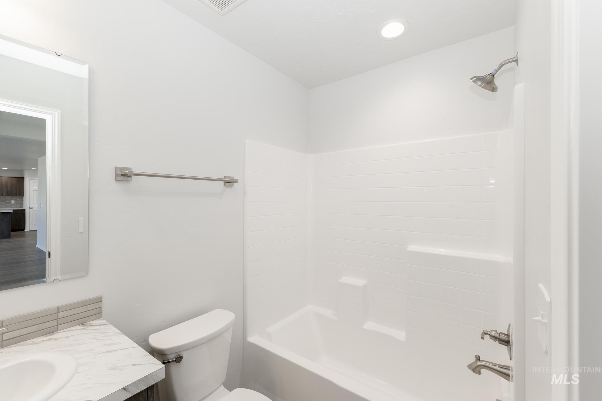 Full bathroom featuring shower / tub combination, vanity, and recessed lighting