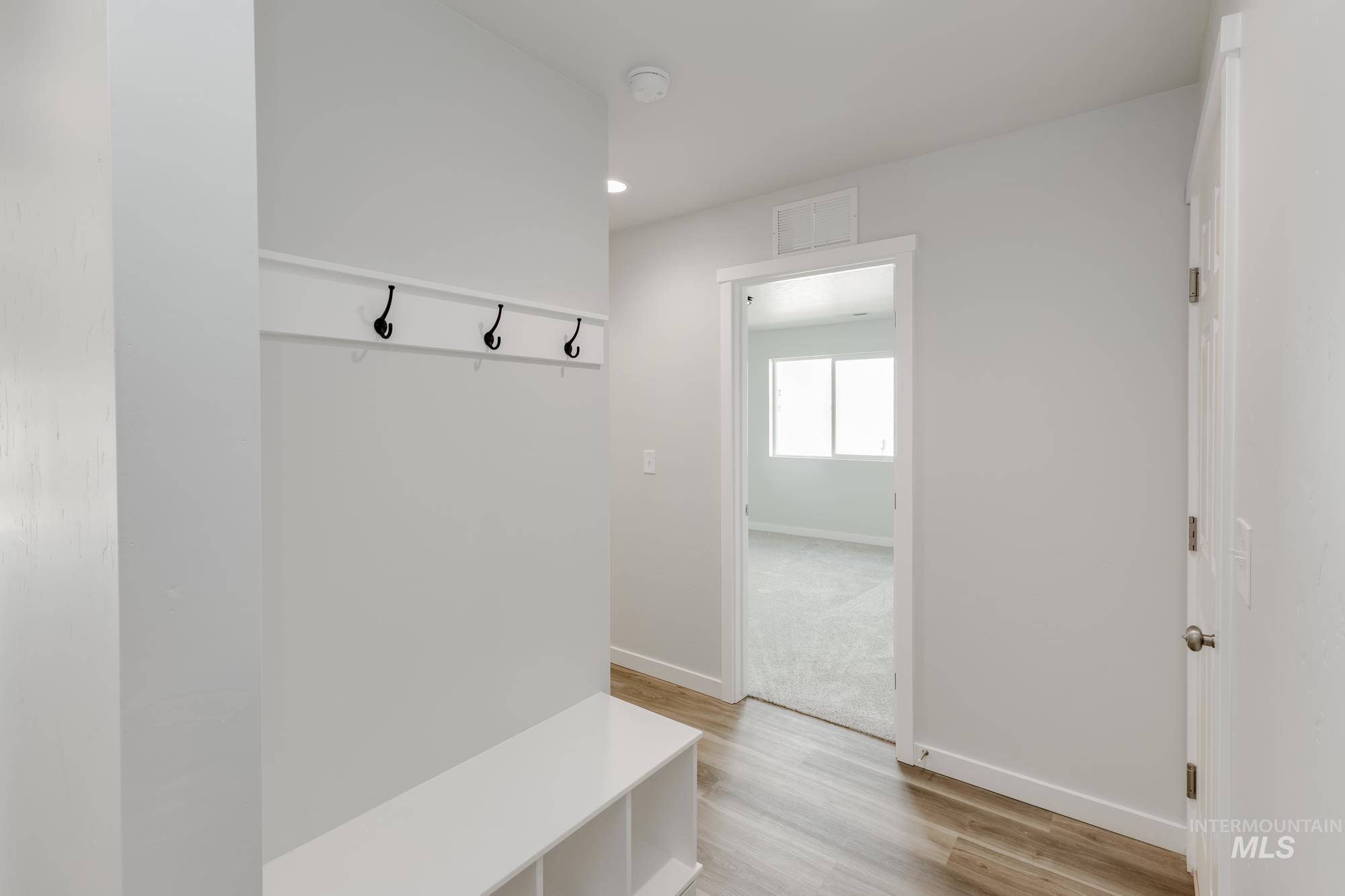 Mudroom with light wood-style flooring and recessed lighting