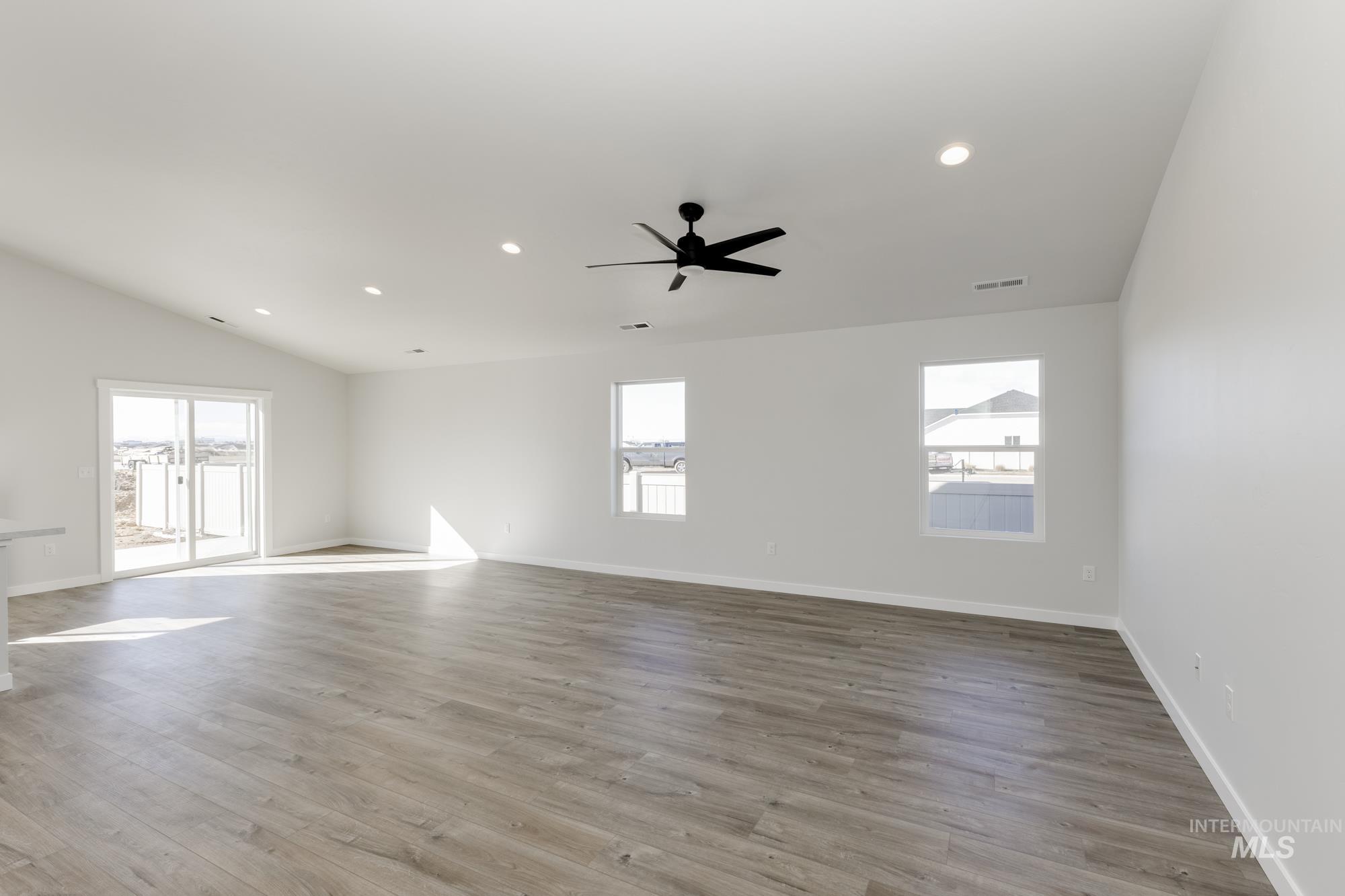 Unfurnished room featuring recessed lighting, light wood-type flooring, ceiling fan, and vaulted ceiling