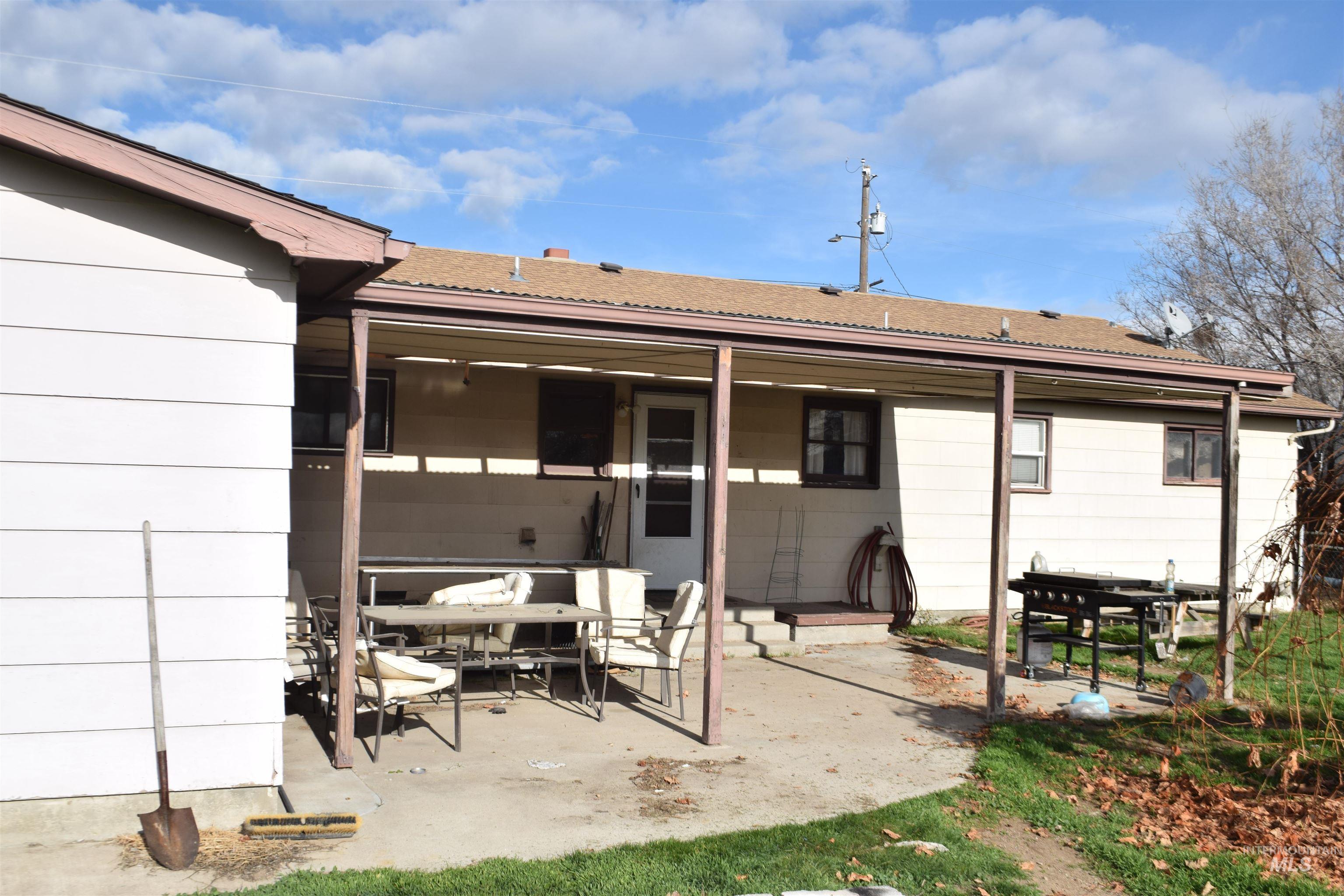 Rear view of property with a patio and outdoor dining space