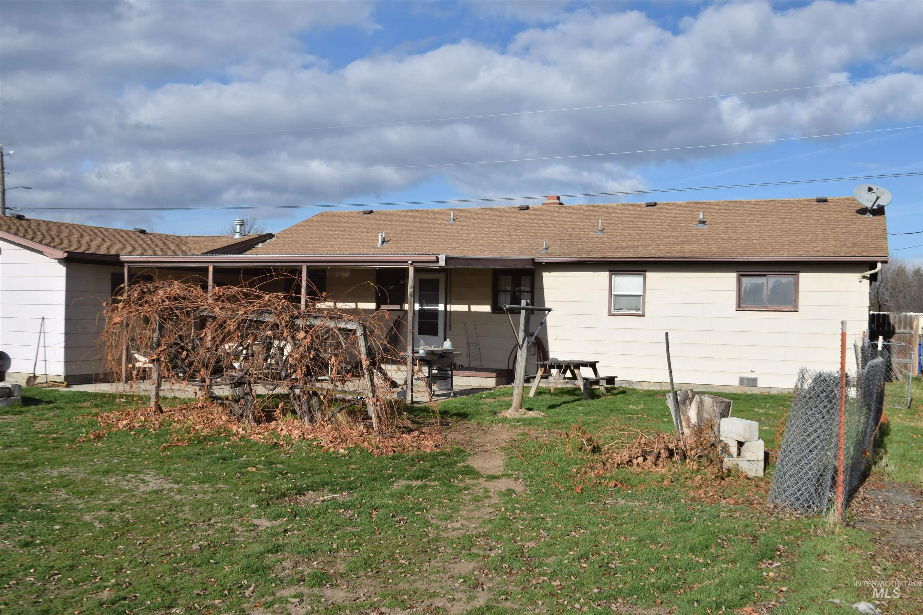 Back of property with a shingled roof