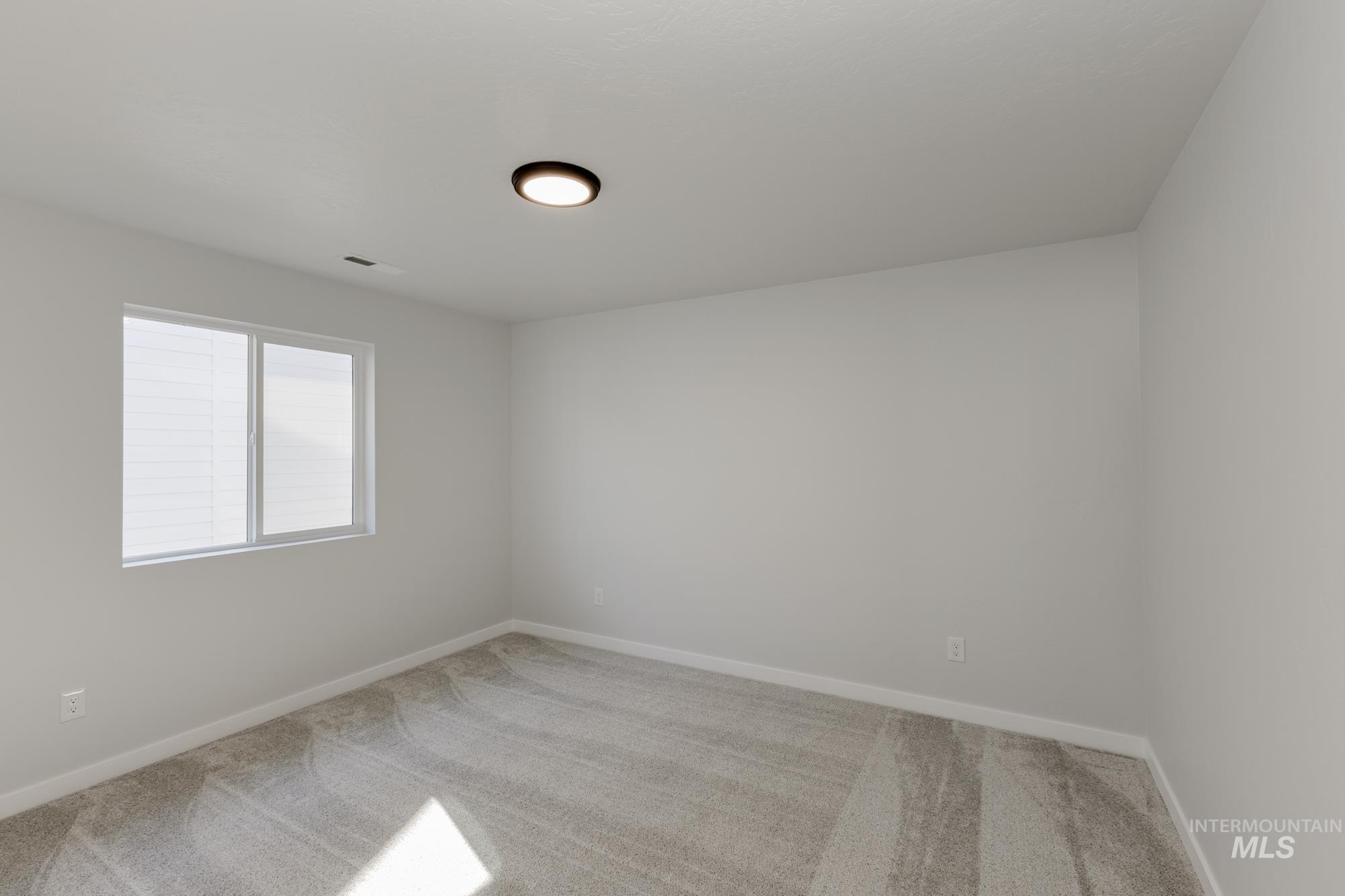 Unfurnished room featuring carpet and baseboards