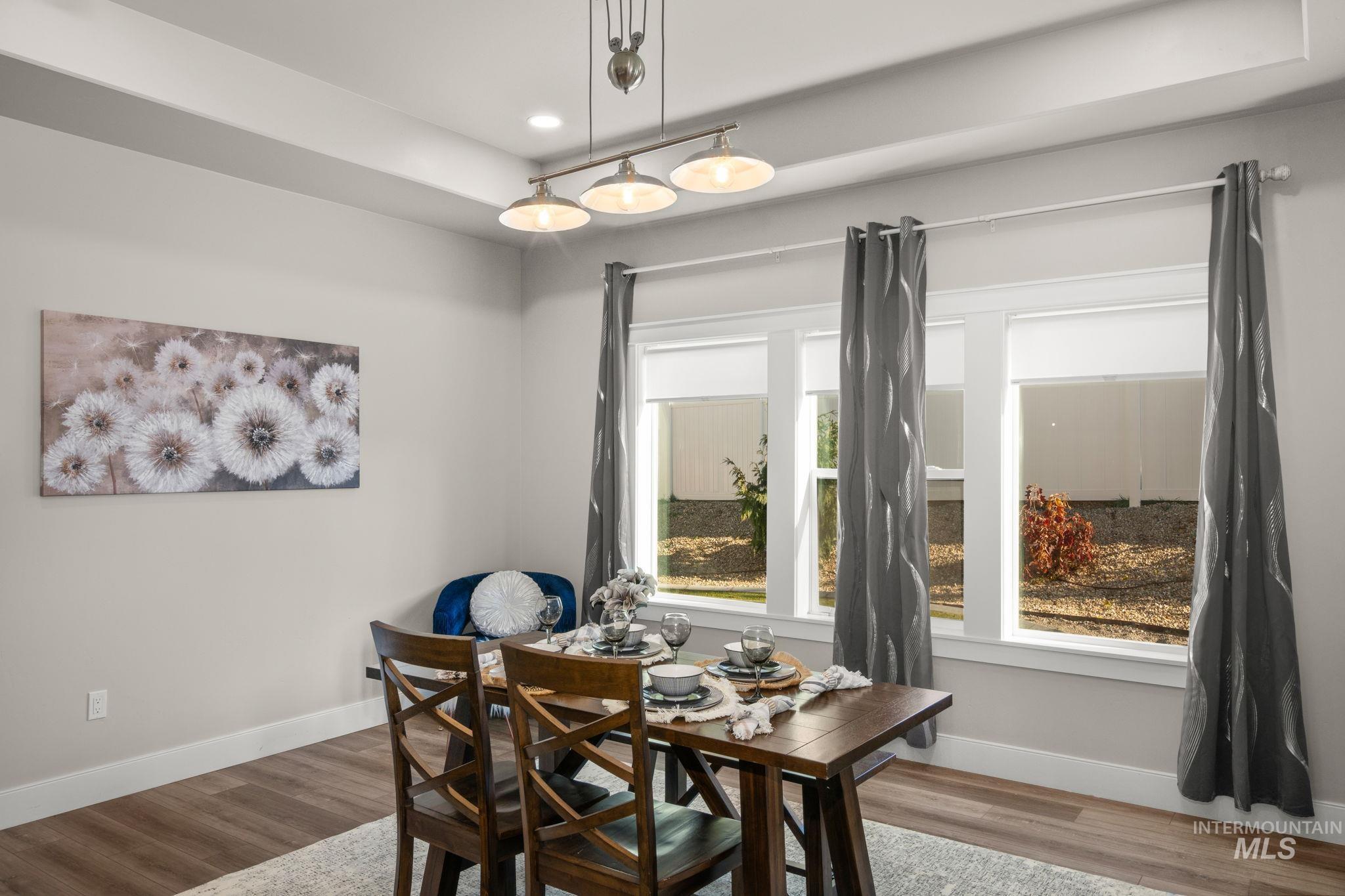 Dining room with light wood-type flooring and recessed lighting