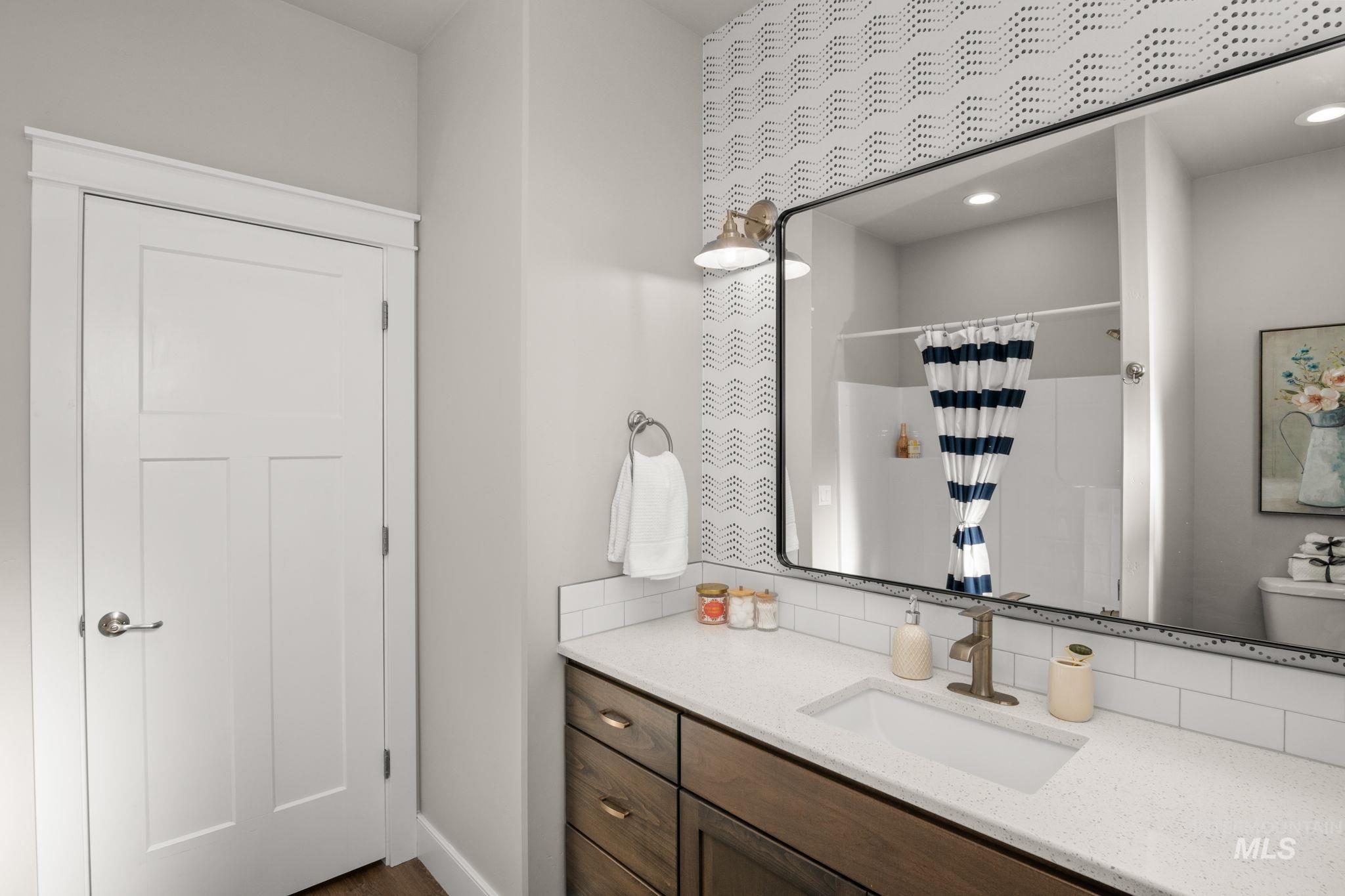 Full bathroom featuring decorative backsplash, a shower with curtain, vanity, and recessed lighting