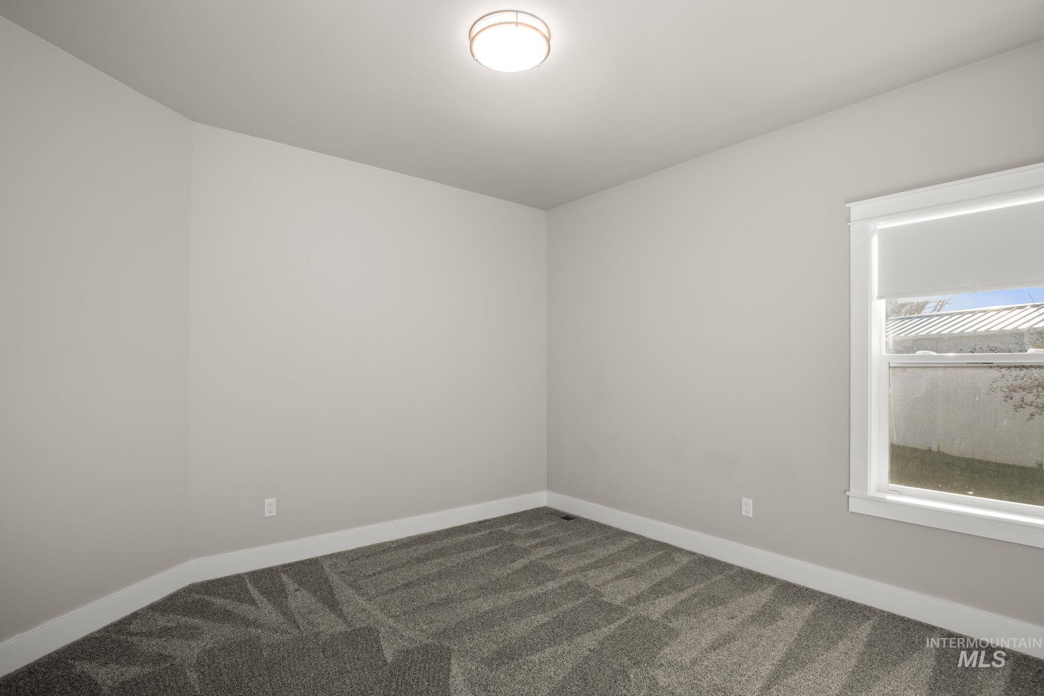 Unfurnished room featuring baseboards and carpet flooring