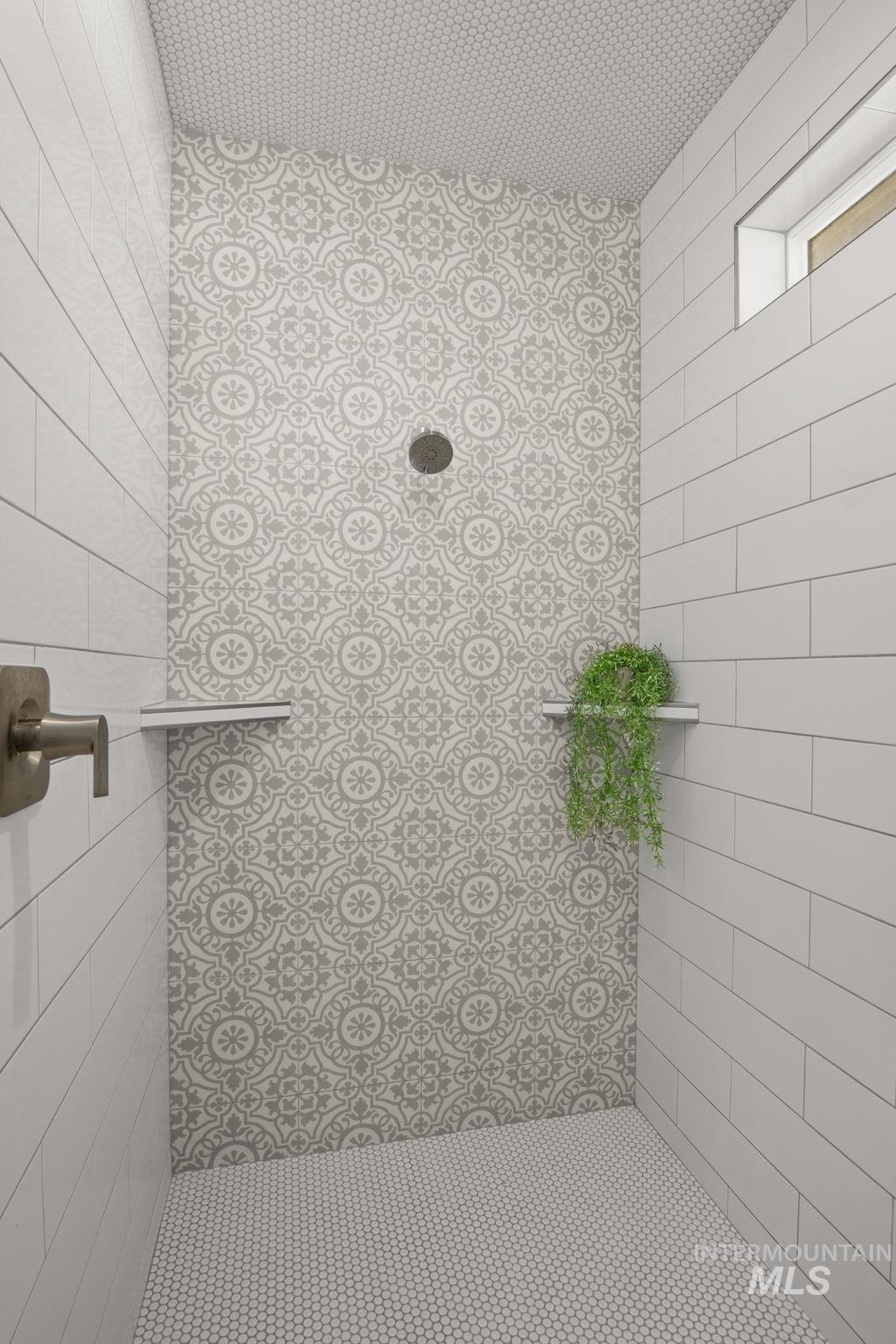 Bathroom featuring tiled shower