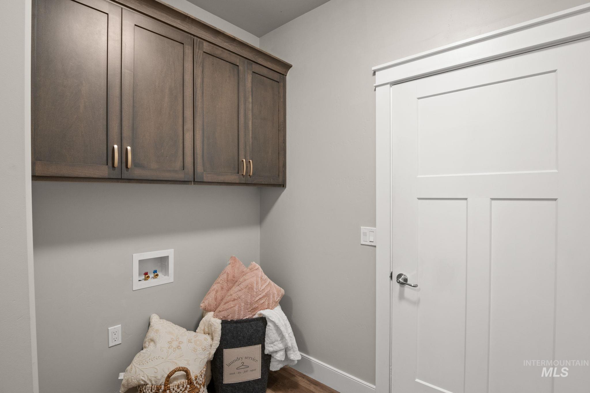 Laundry area with hookup for a washing machine and cabinet space