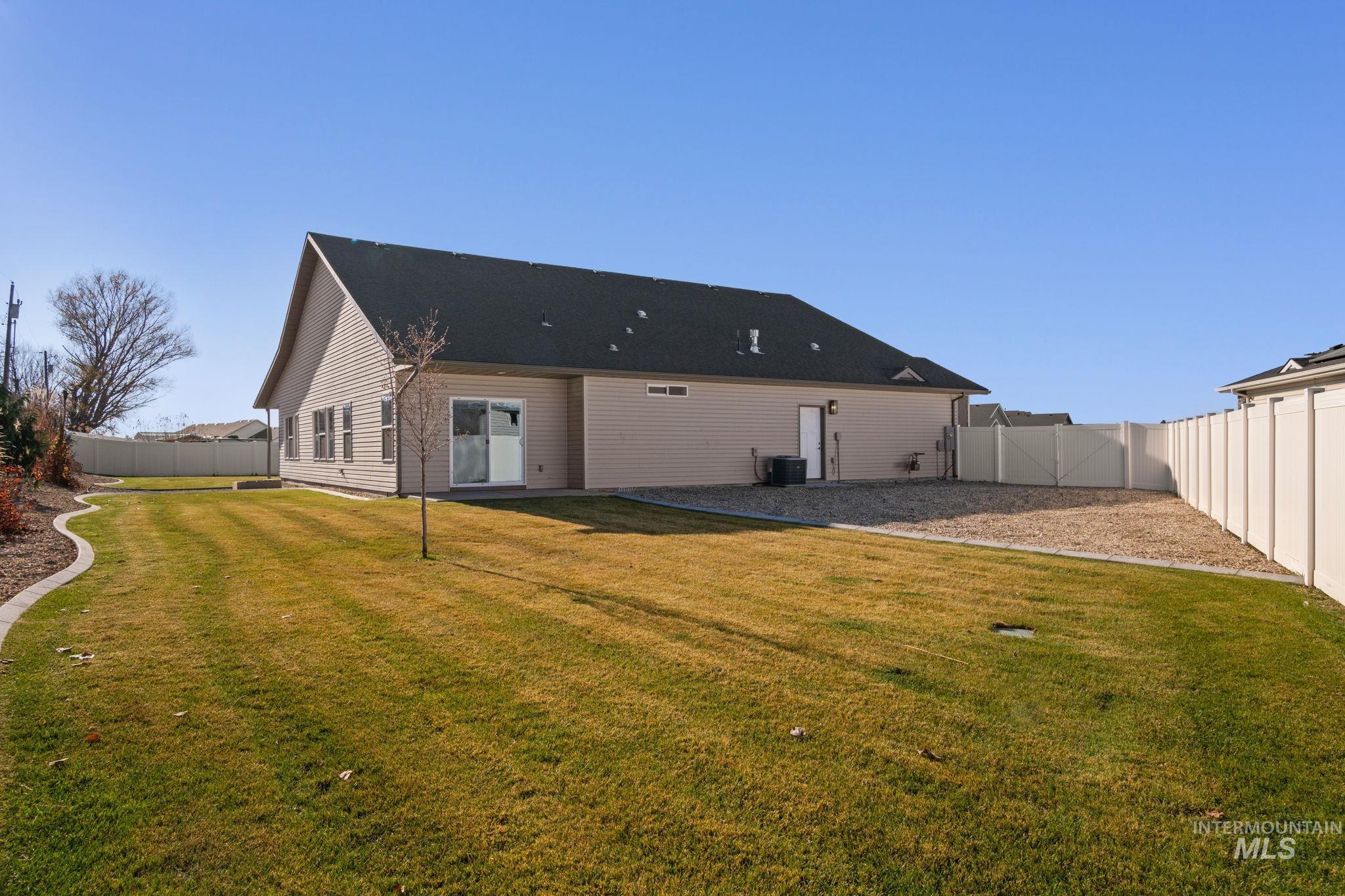 Rear view of property with a fenced backyard