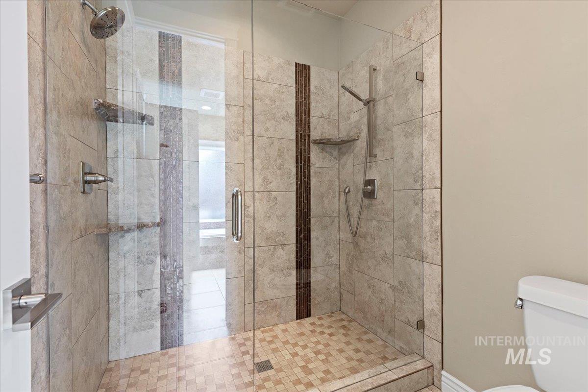 Full bath with a stall shower and toilet