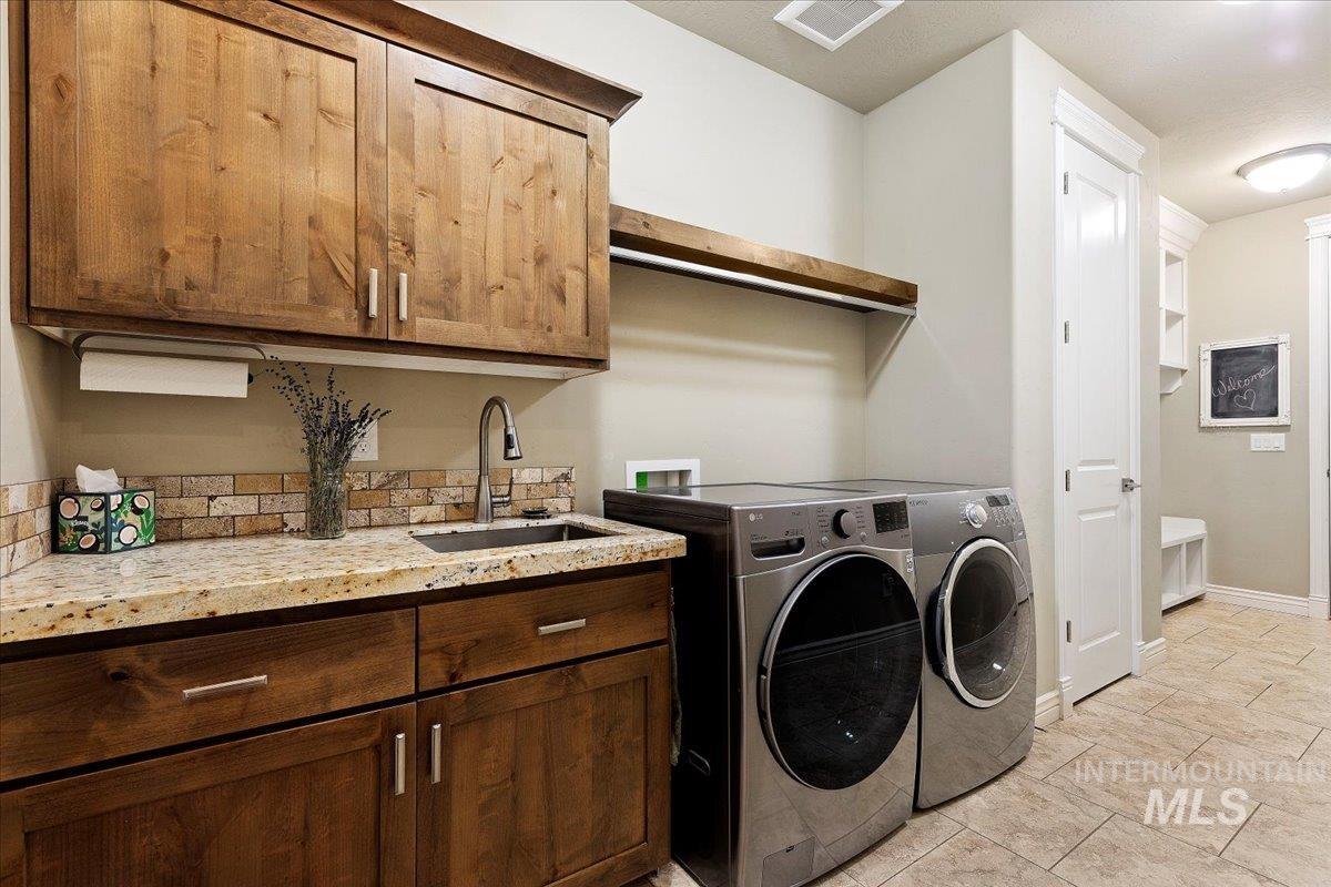 Laundry area with washing machine and dryer and cabinet space
