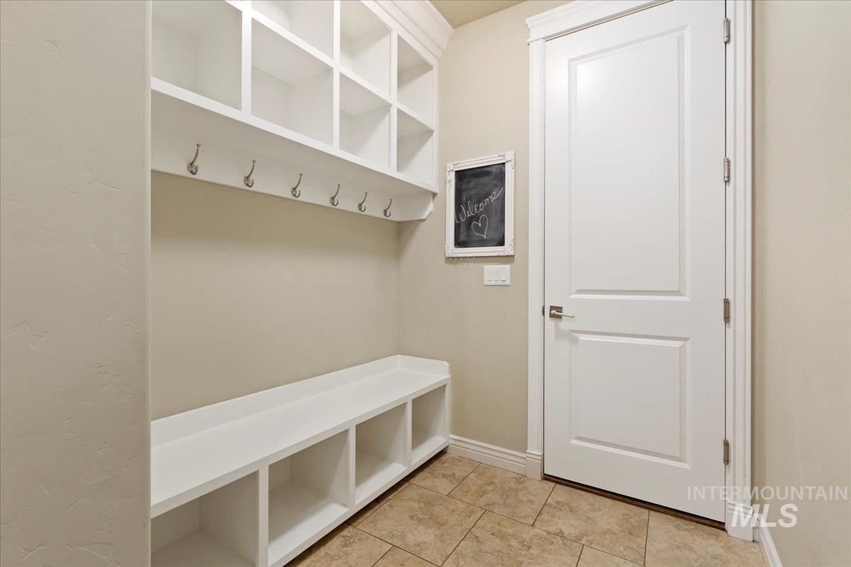 Mudroom featuring baseboards and light tile patterned floors