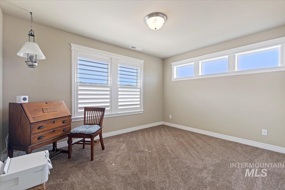 Sitting room featuring carpet and baseboards