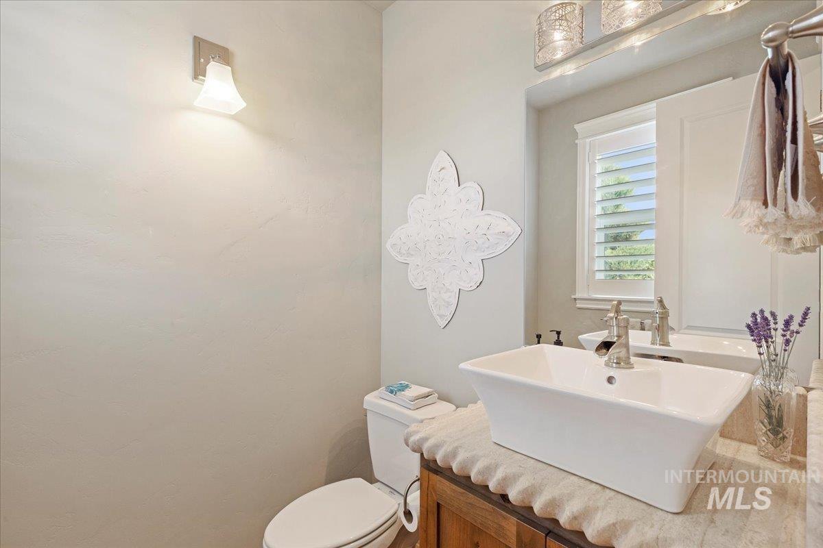 Half bathroom featuring vanity and toilet