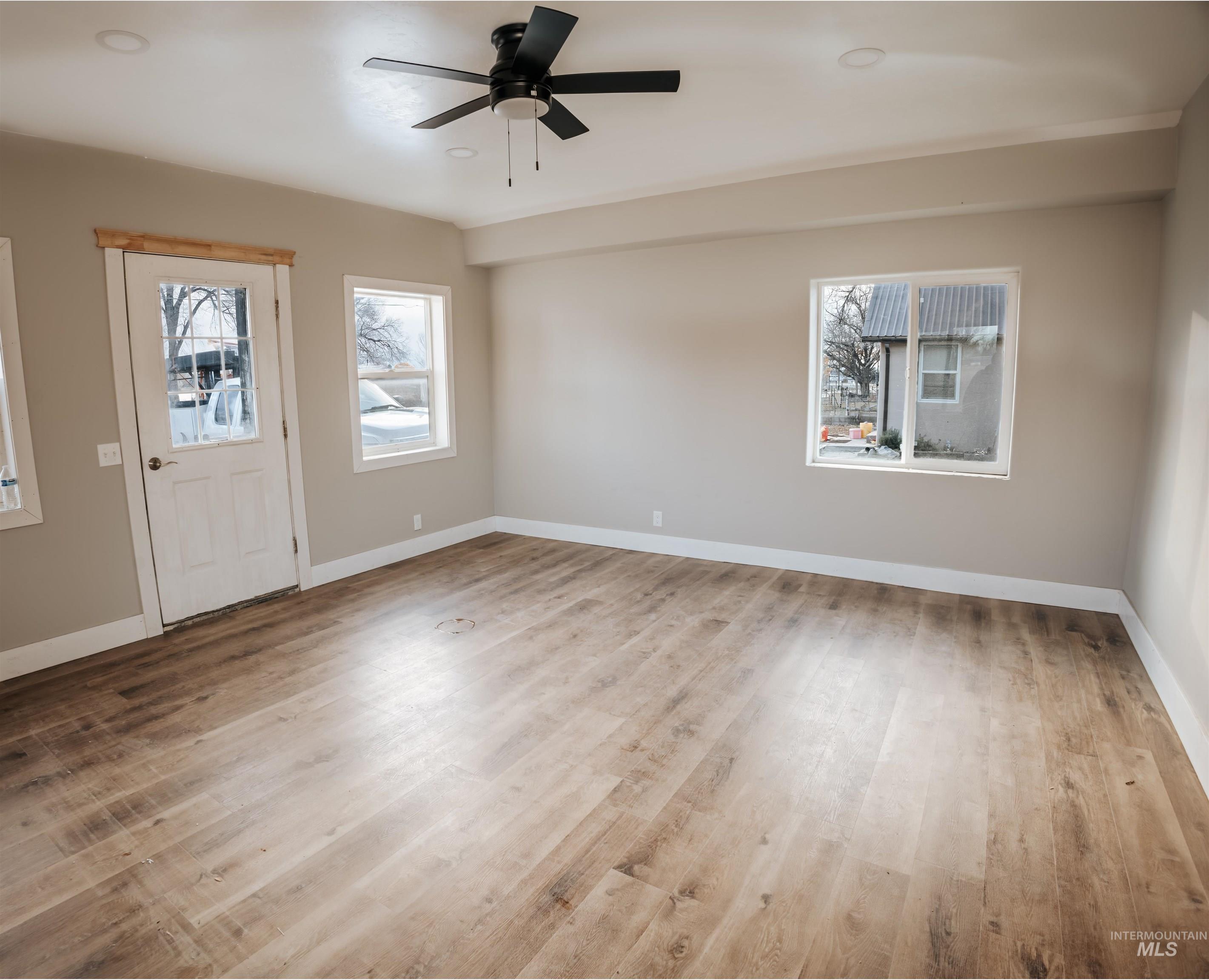 Foyer with light wood-type flooring, a ceiling fan, and recessed lighting