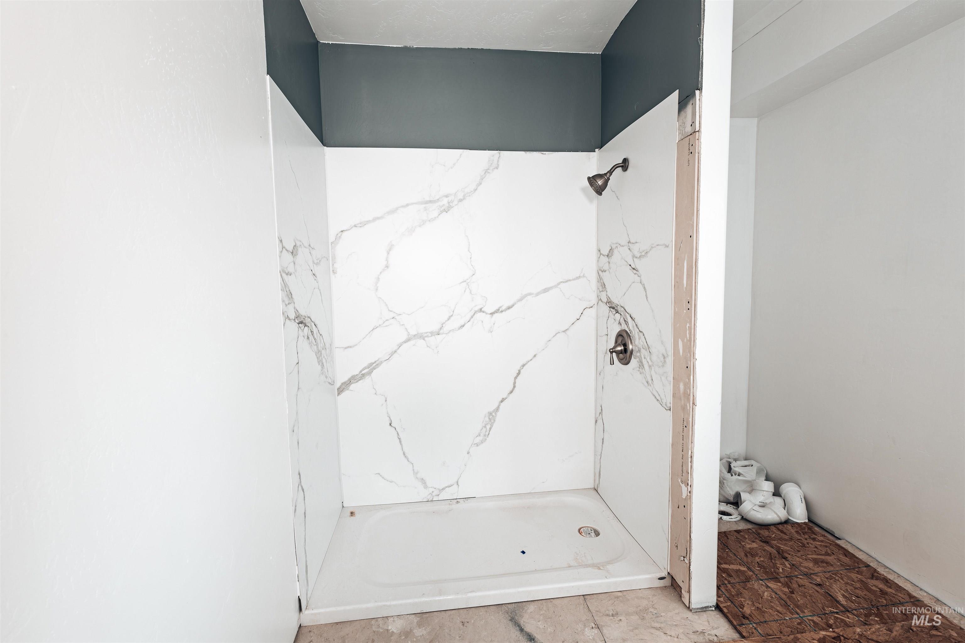 Bathroom with a marble finish shower