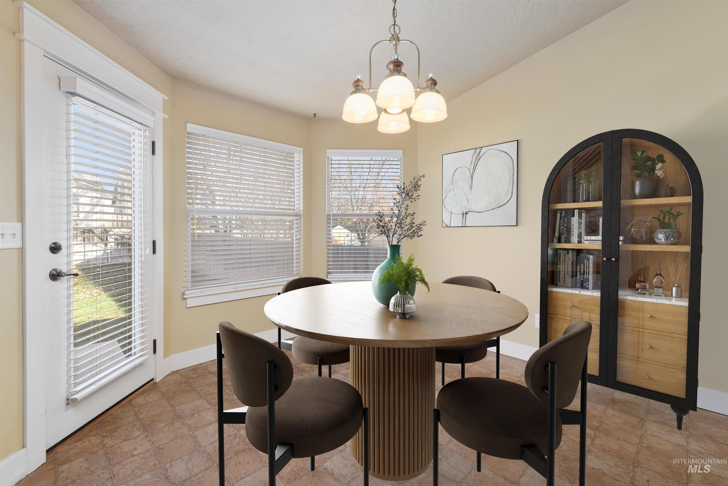 Virtually Staged - Dining area featuring a chandelier, arched walkways looking over large backyard.